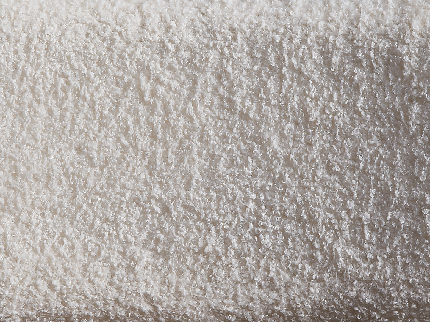 Closeup of fluffy cream teddy bear fabric texture with soft curled fibers