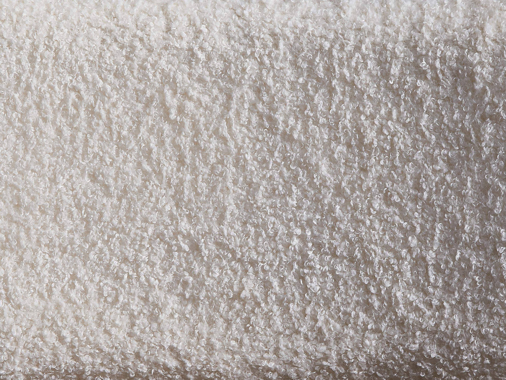 Closeup of fluffy cream teddy bear fabric texture with soft curled fibers