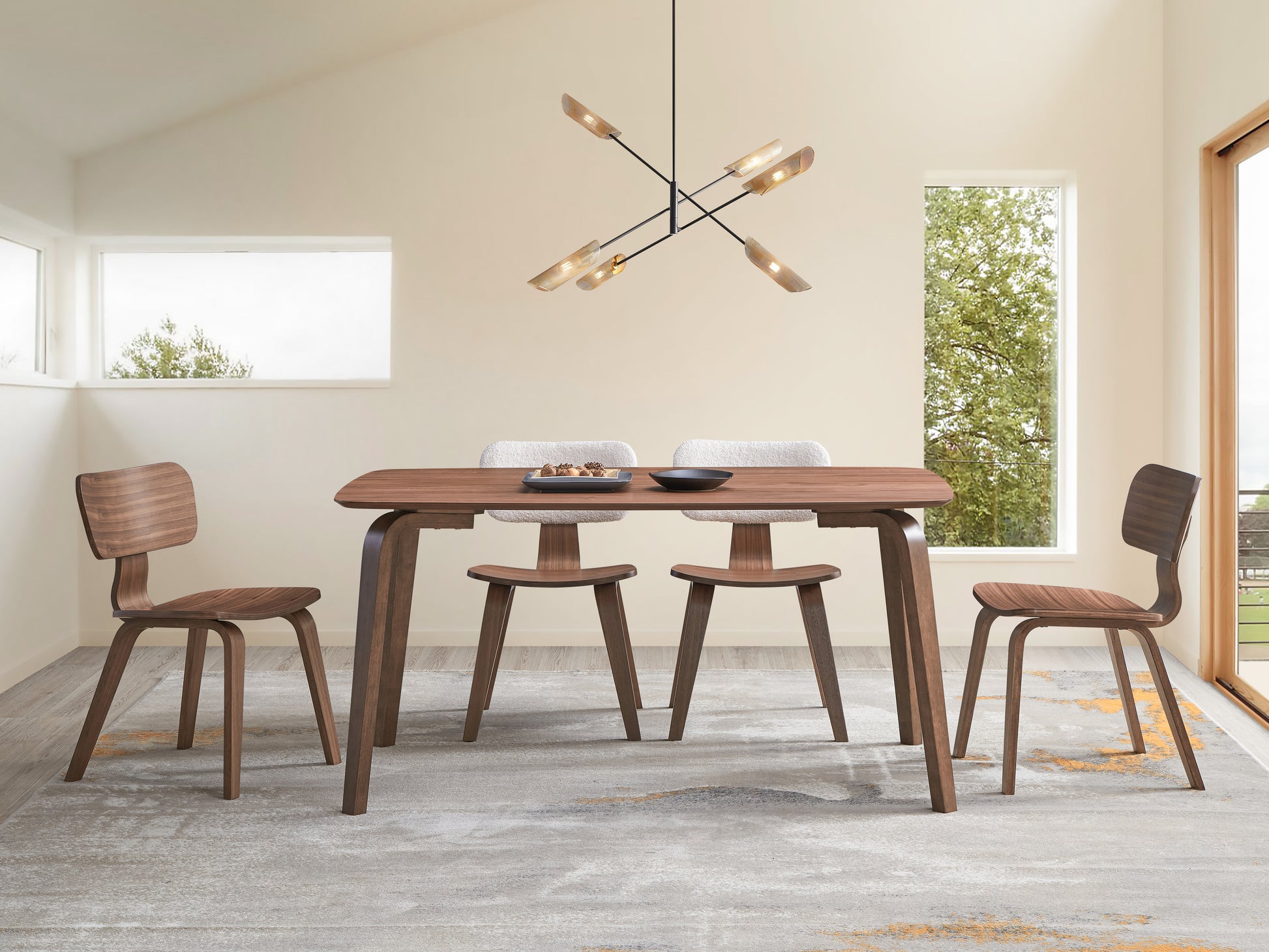 Modern walnut dining table with curved legs and matching chairs ideal for contemporary dining spaces