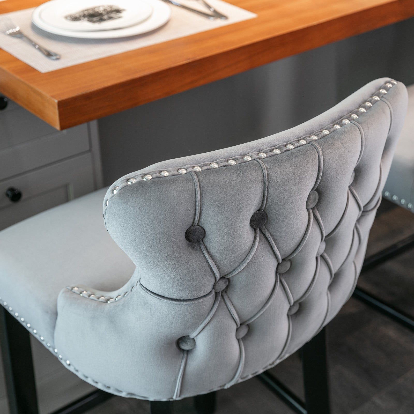 Grey velvet tufted bar stool with silver nailhead trim