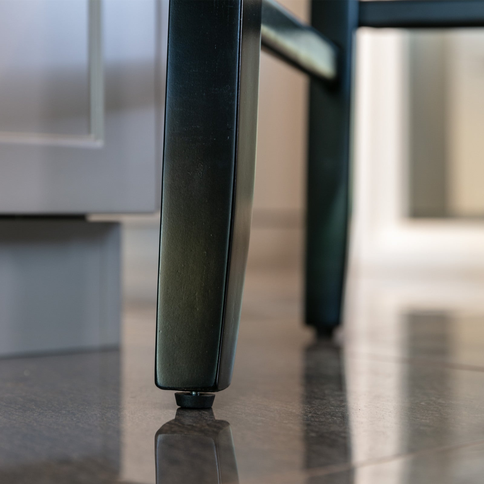 Black metal chair leg with adjustable foot