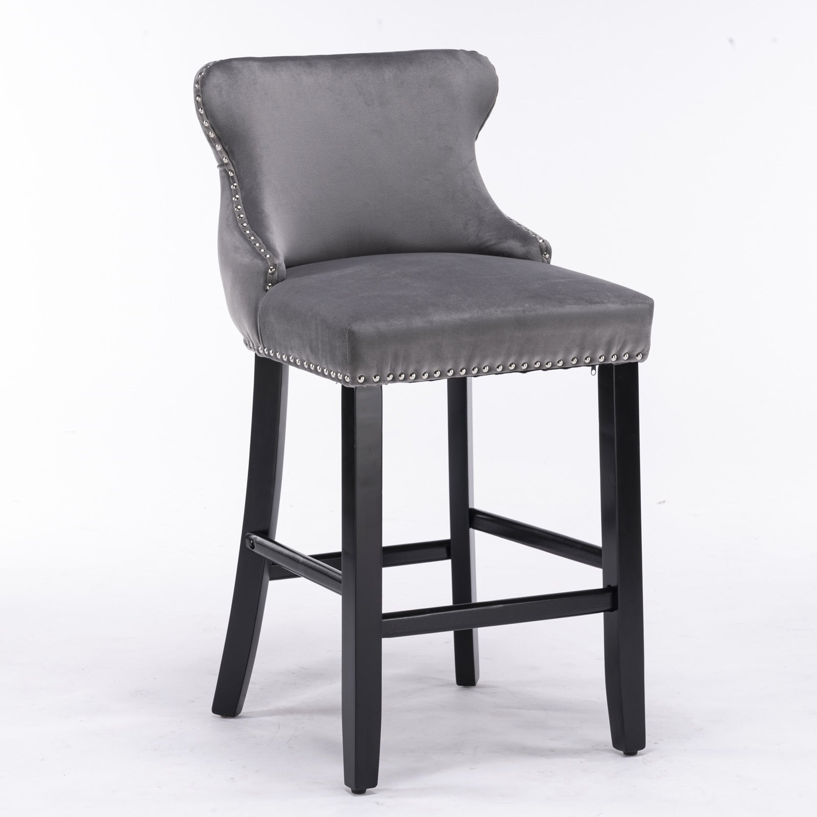 Gray velvet tufted bar stool with silver nailhead trim and black wooden legs