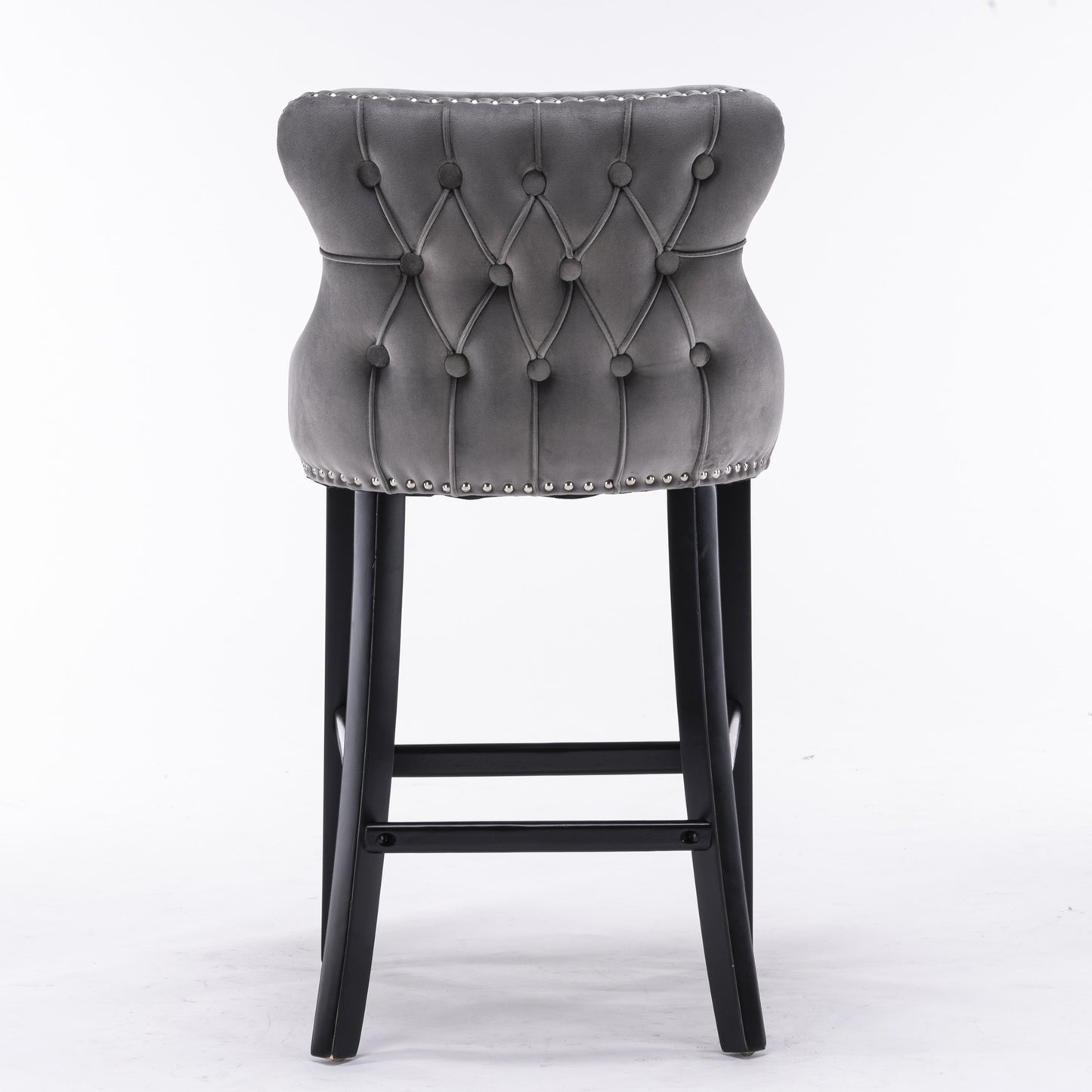 Grey velvet tufted bar stool with silver nailhead trim and dark wood legs