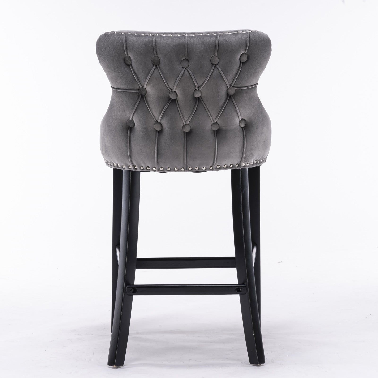 Grey velvet tufted bar stool with silver nailhead trim and dark wood legs