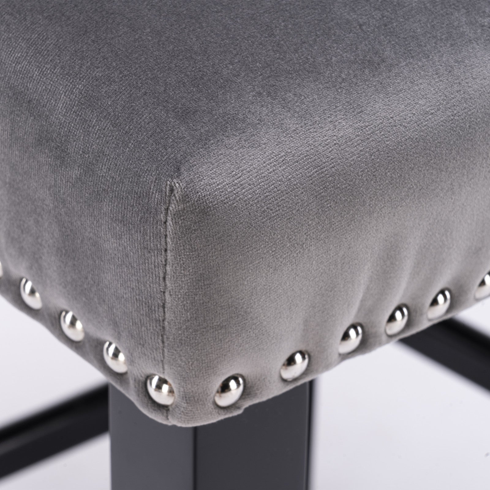 Grey velvet stool cushion with decorative silver nailhead trim detail