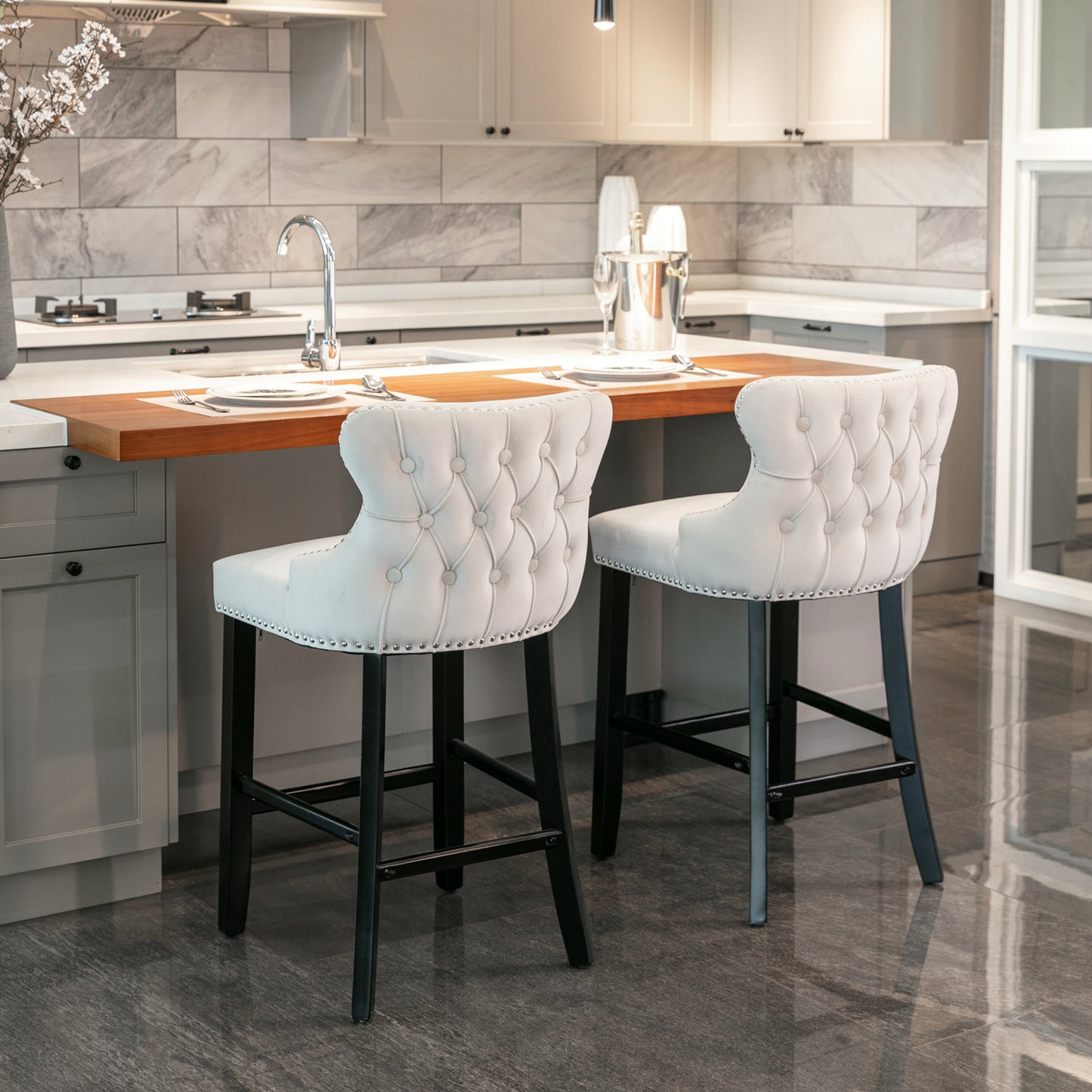 Tufted cream velvet bar stool with silver nailhead trim and black legs