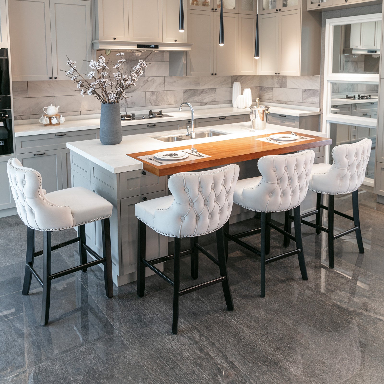 Tufted white velvet bar stool with silver nailhead trim and black legs