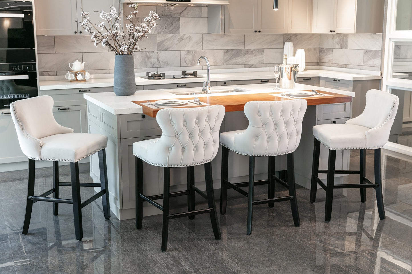 White tufted bar stool with nailhead trim and black legs