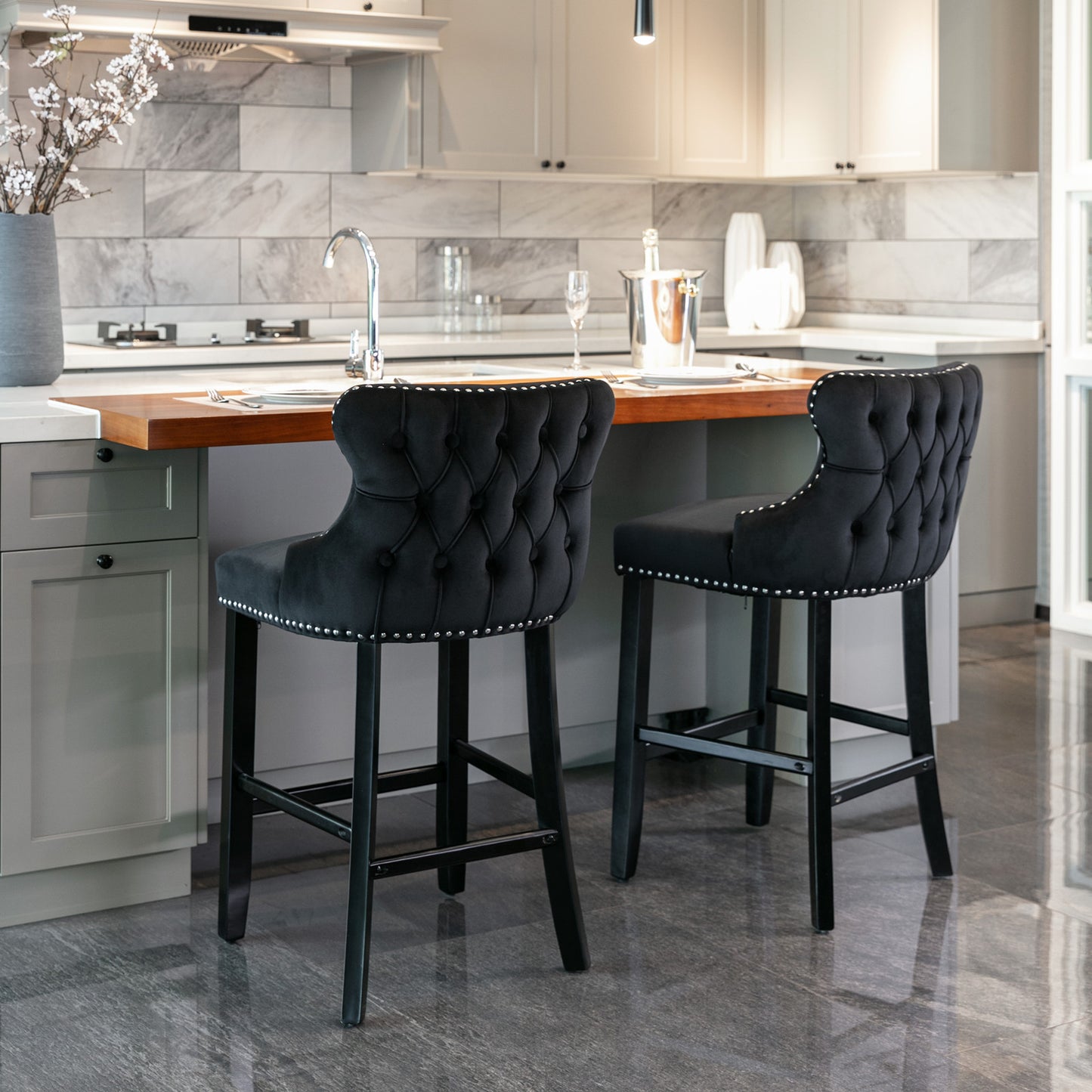 Black velvet tufted bar stool with silver nailhead trim