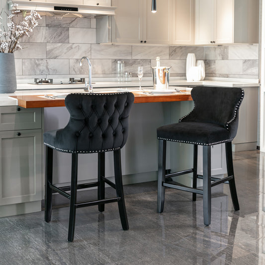 Black velvet tufted bar stool with silver nailhead trim
