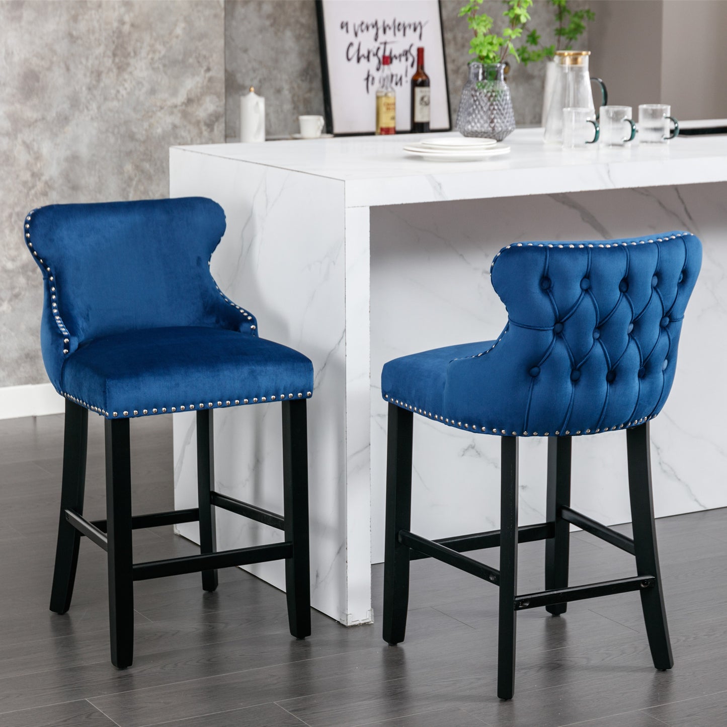 Blue velvet tufted bar stool with silver nailhead trim and dark wood legs
