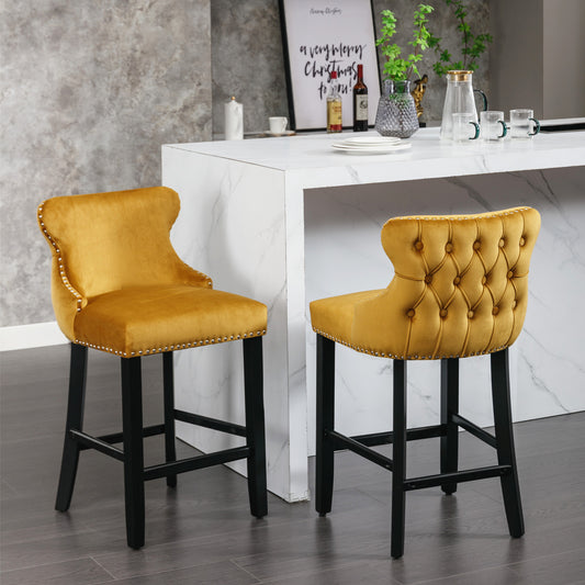 Yellow velvet tufted bar stool with nailhead trim and black legs