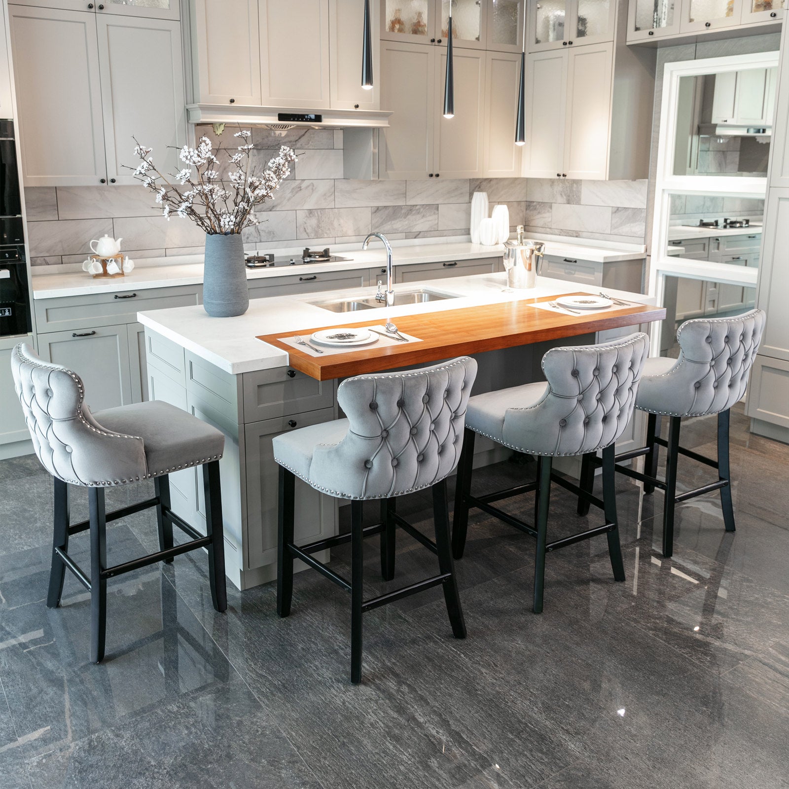 Grey velvet tufted bar stool with silver nailhead trim and black legs
