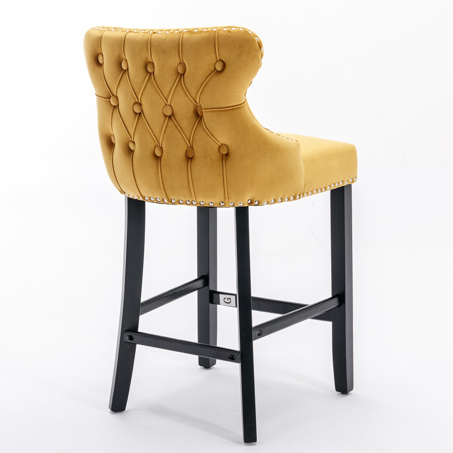 Tufted gold velvet bar stool with silver nailhead trim and black wooden legs