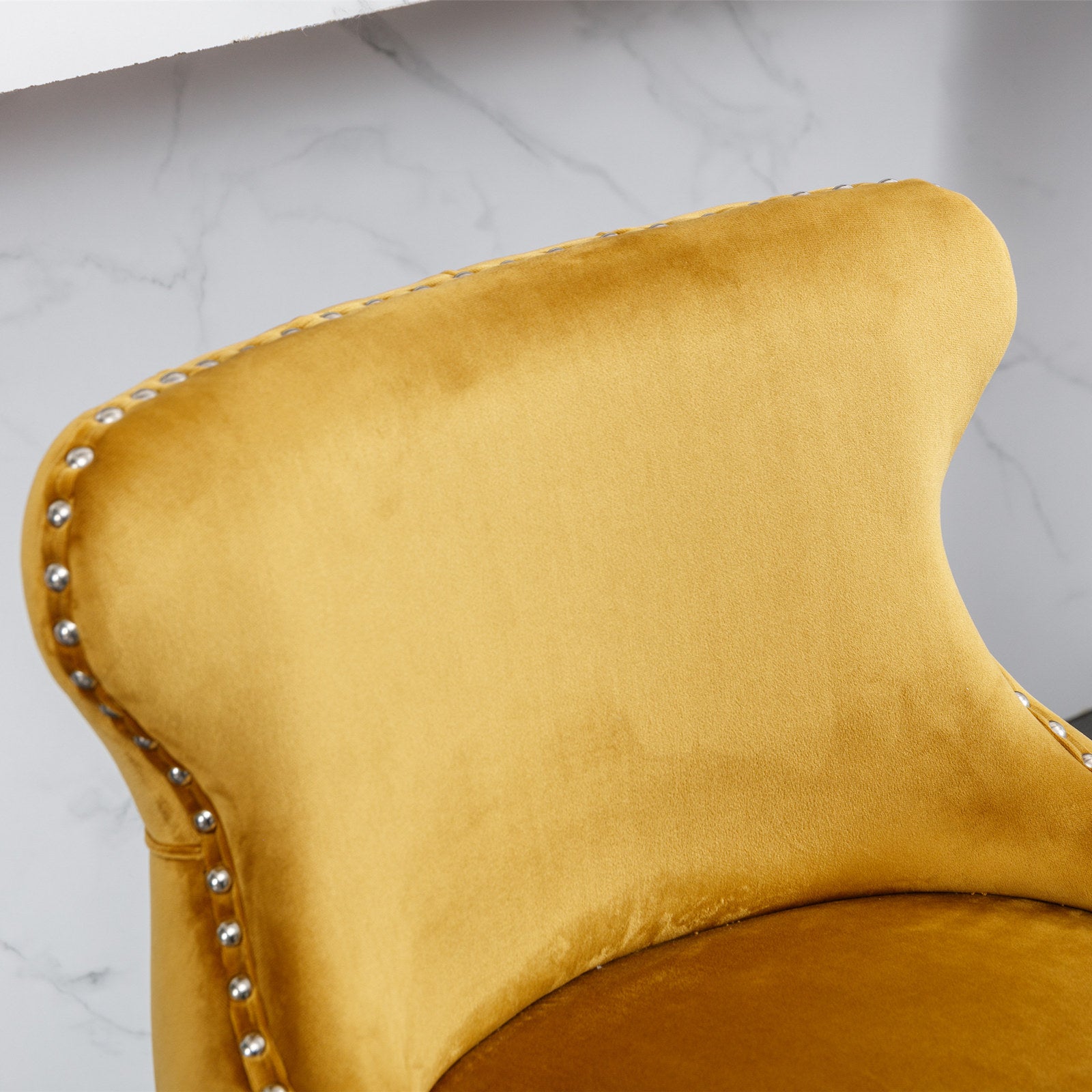 Luxurious mustard yellow velvet dining chair with silver nailhead trim