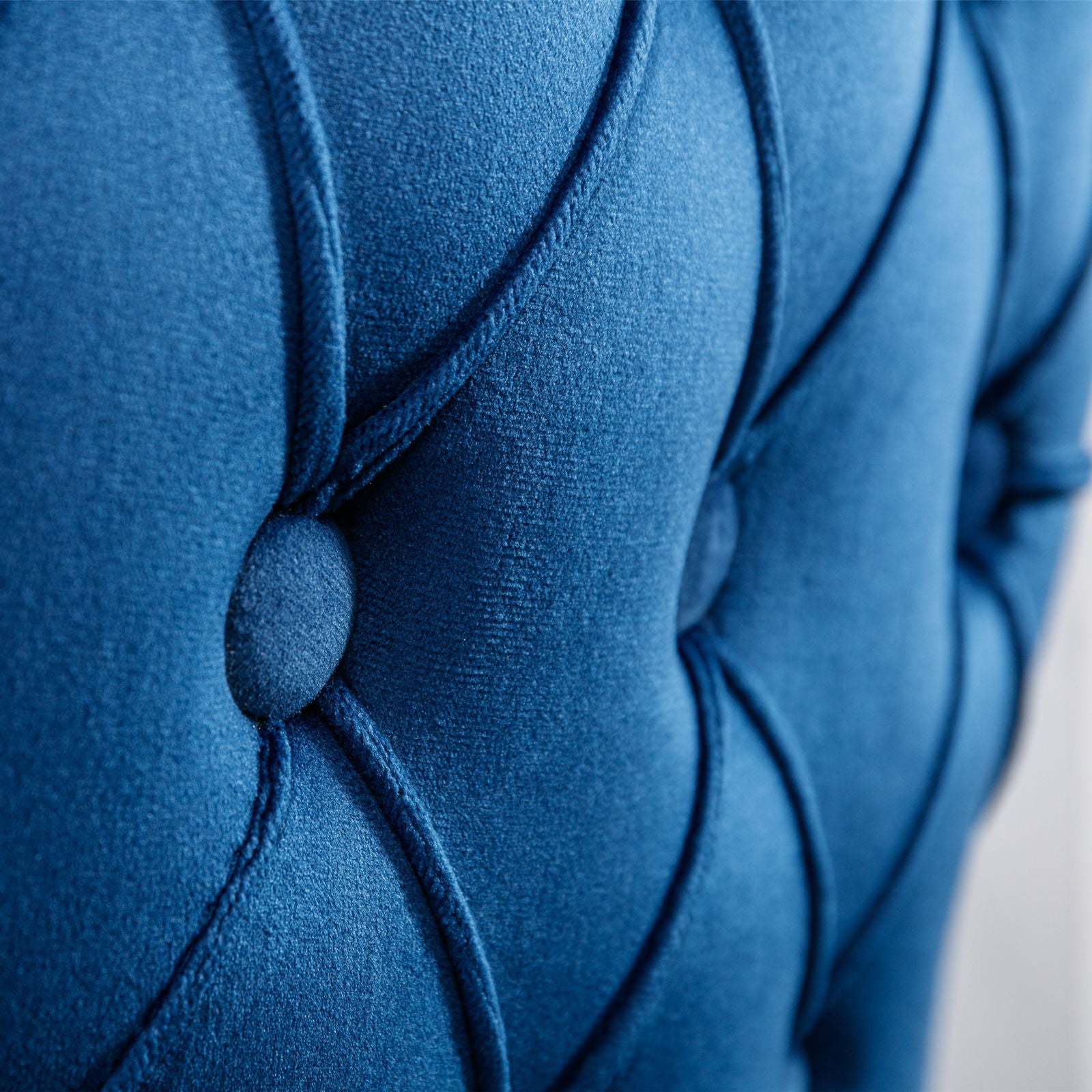 Deep blue velvet tufted accent chair back detail