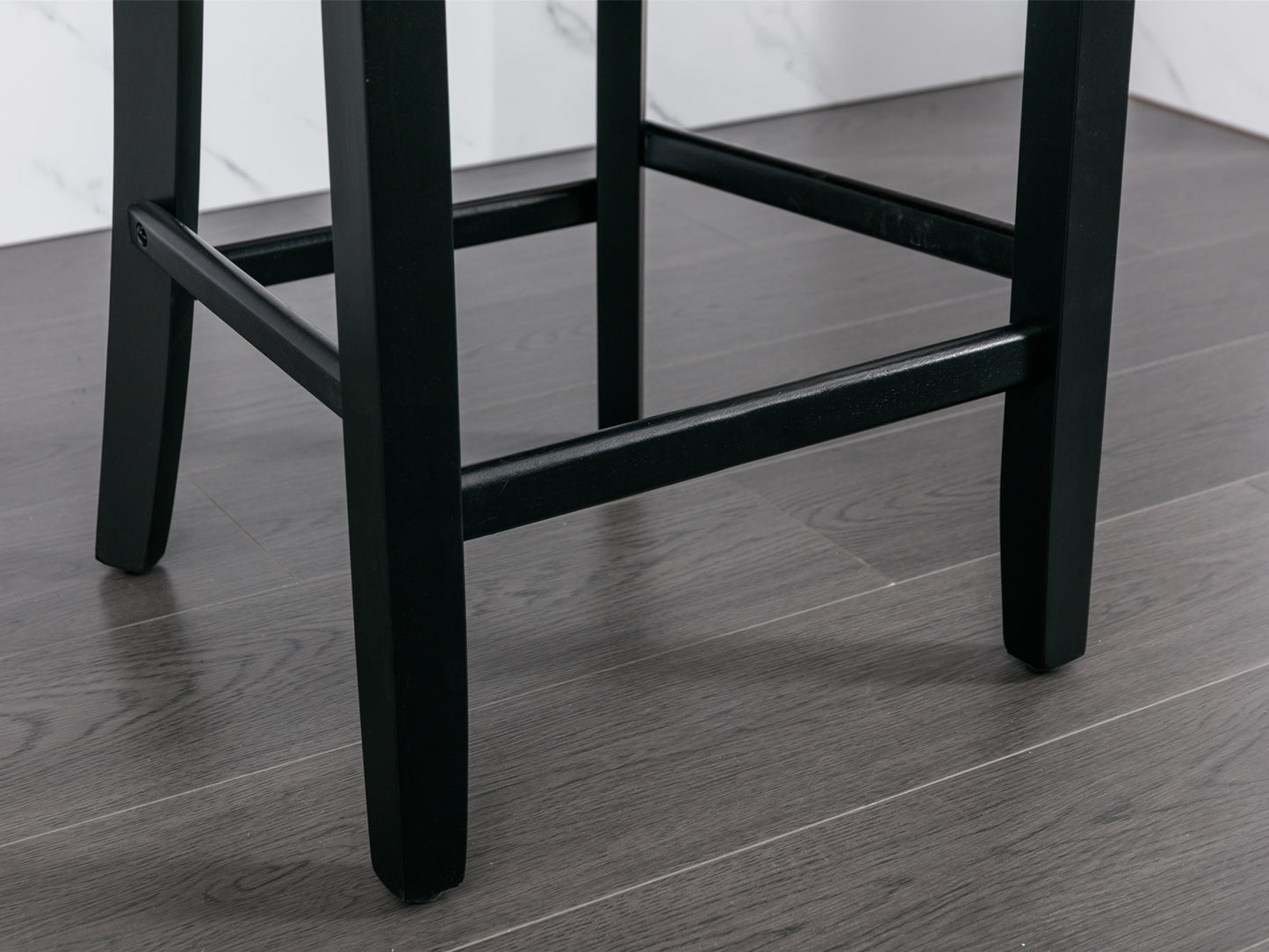 Black wooden bar stool legs on grey wood floor
