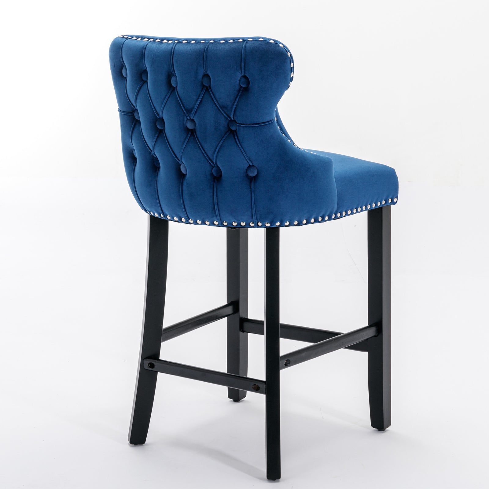 Tufted navy blue velvet bar stool with silver nailhead trim and dark wood legs