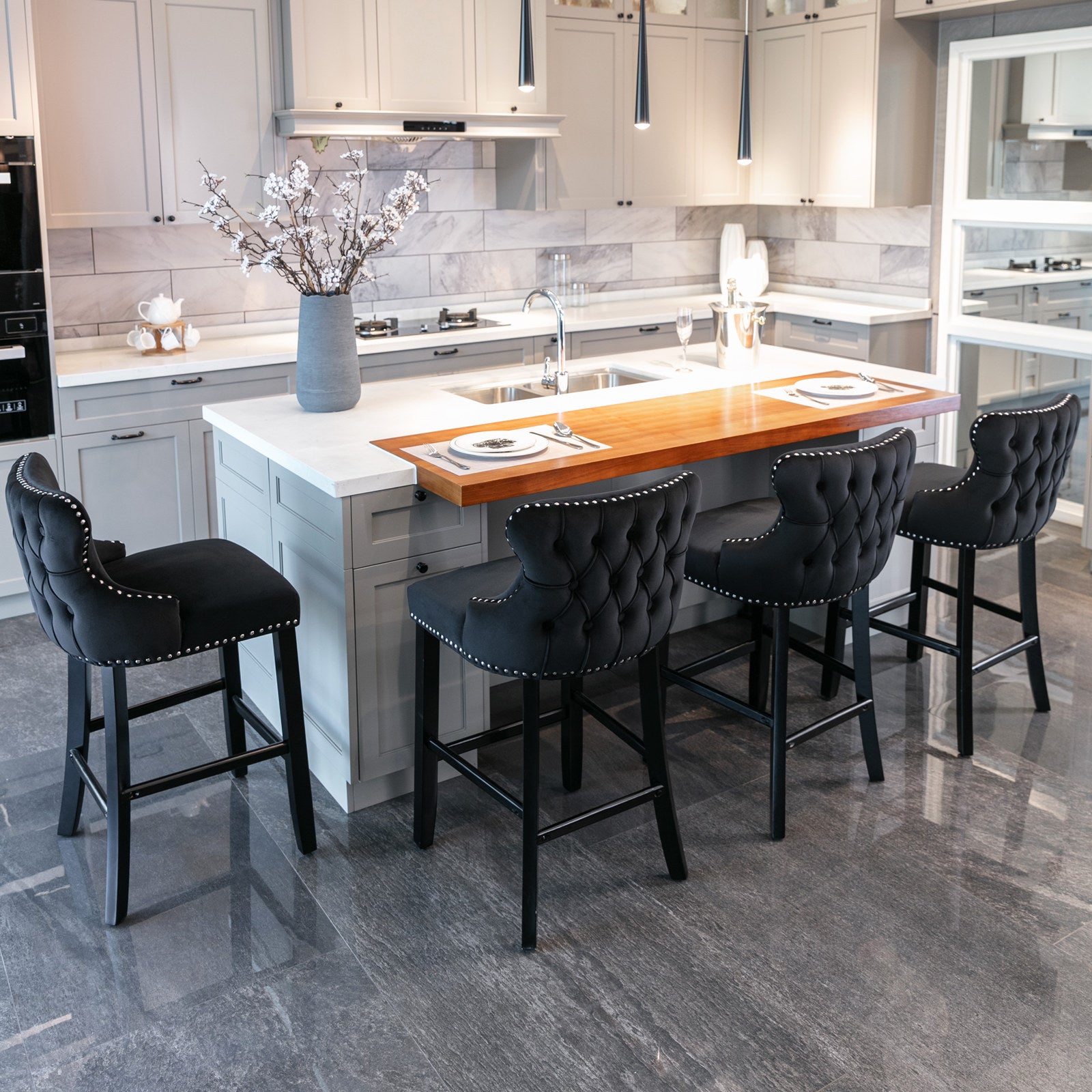 Black velvet tufted bar stool with silver nailhead trim