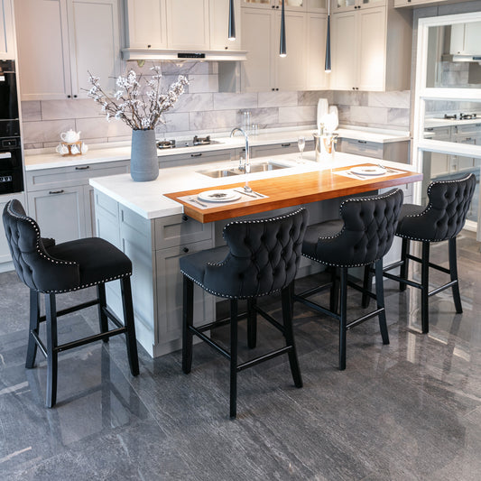 Black velvet tufted bar stool with silver nailhead trim