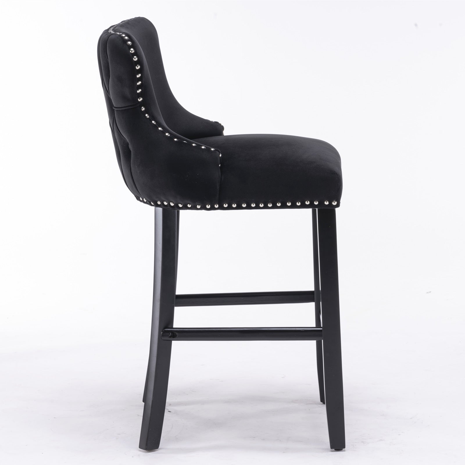 Black velvet tufted bar stool with silver nailhead trim and dark wood legs