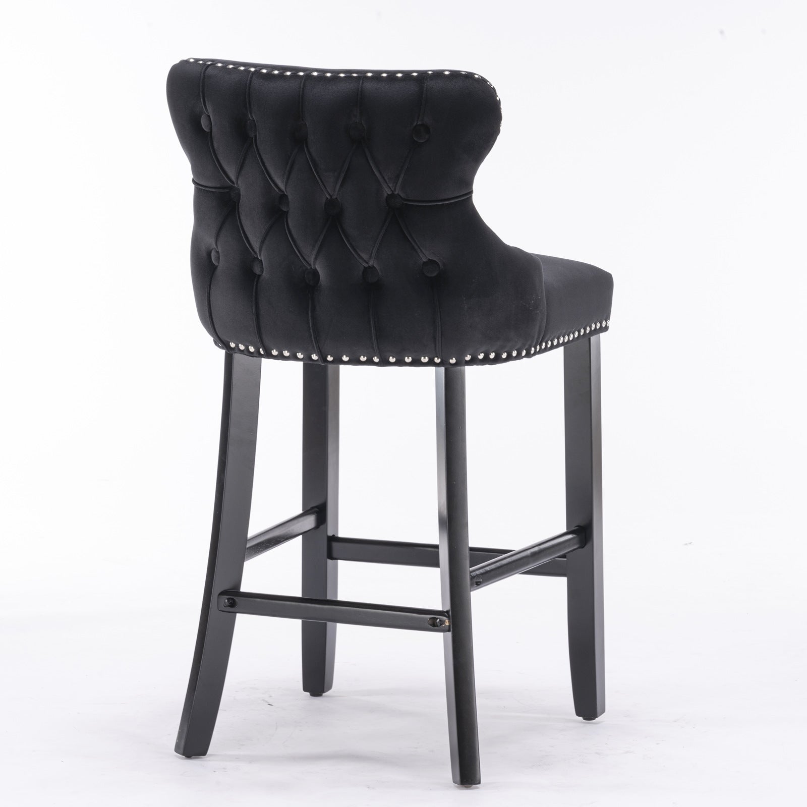 Black velvet bar stool with tufted back and silver nailhead trim