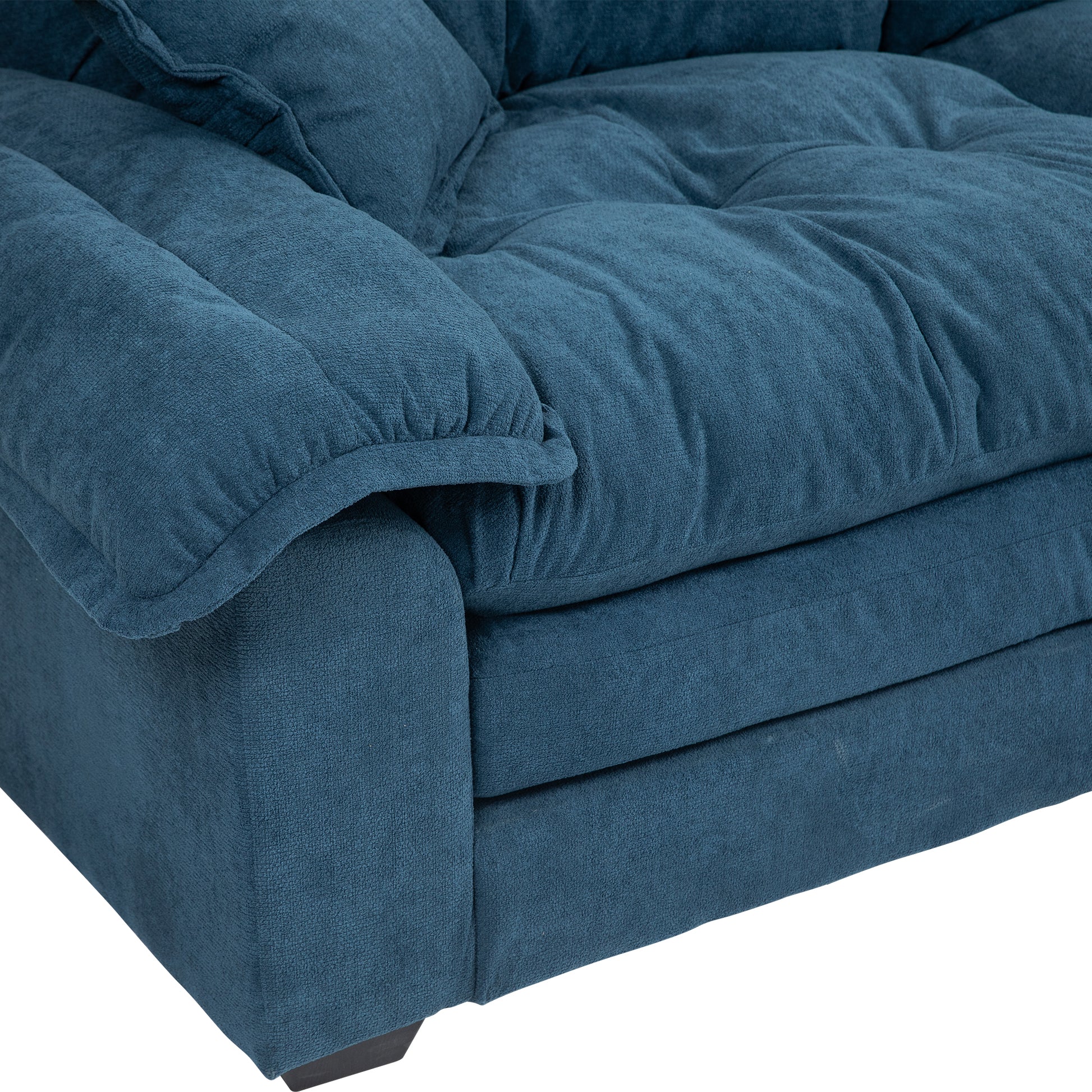 Deep teal textured fabric sofa armrest and seat detail plush comfort for living rooms