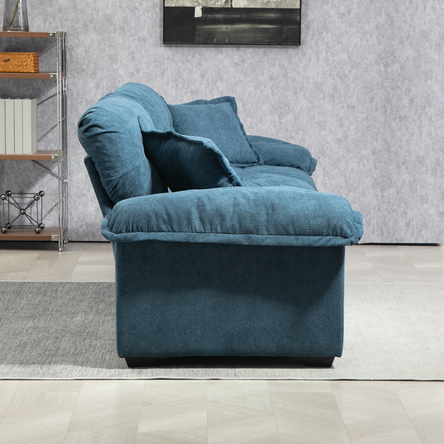 Plush teal fabric sofa with overstuffed cushions and square arms