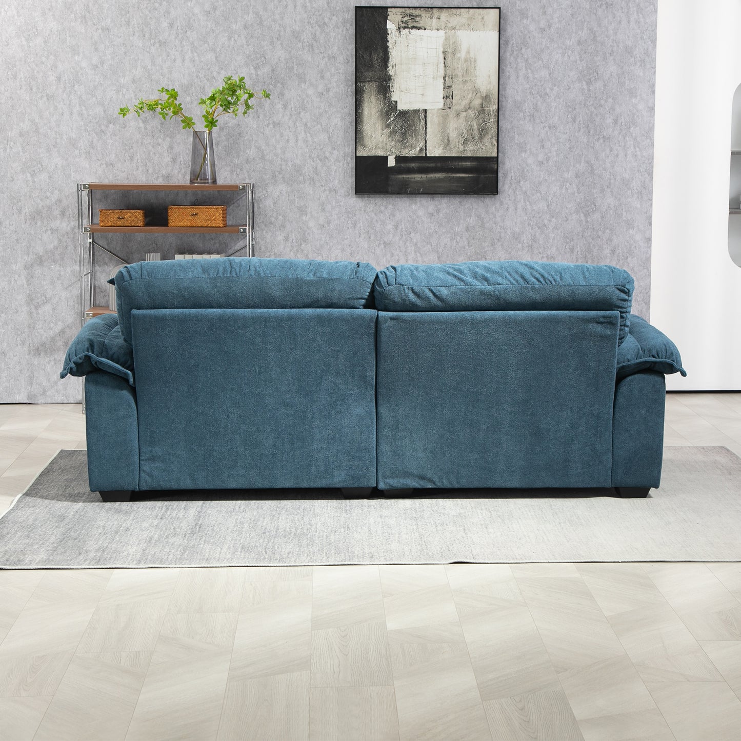 Plush teal sofa with deep cushions and rolled arms perfect for a cozy living room setup