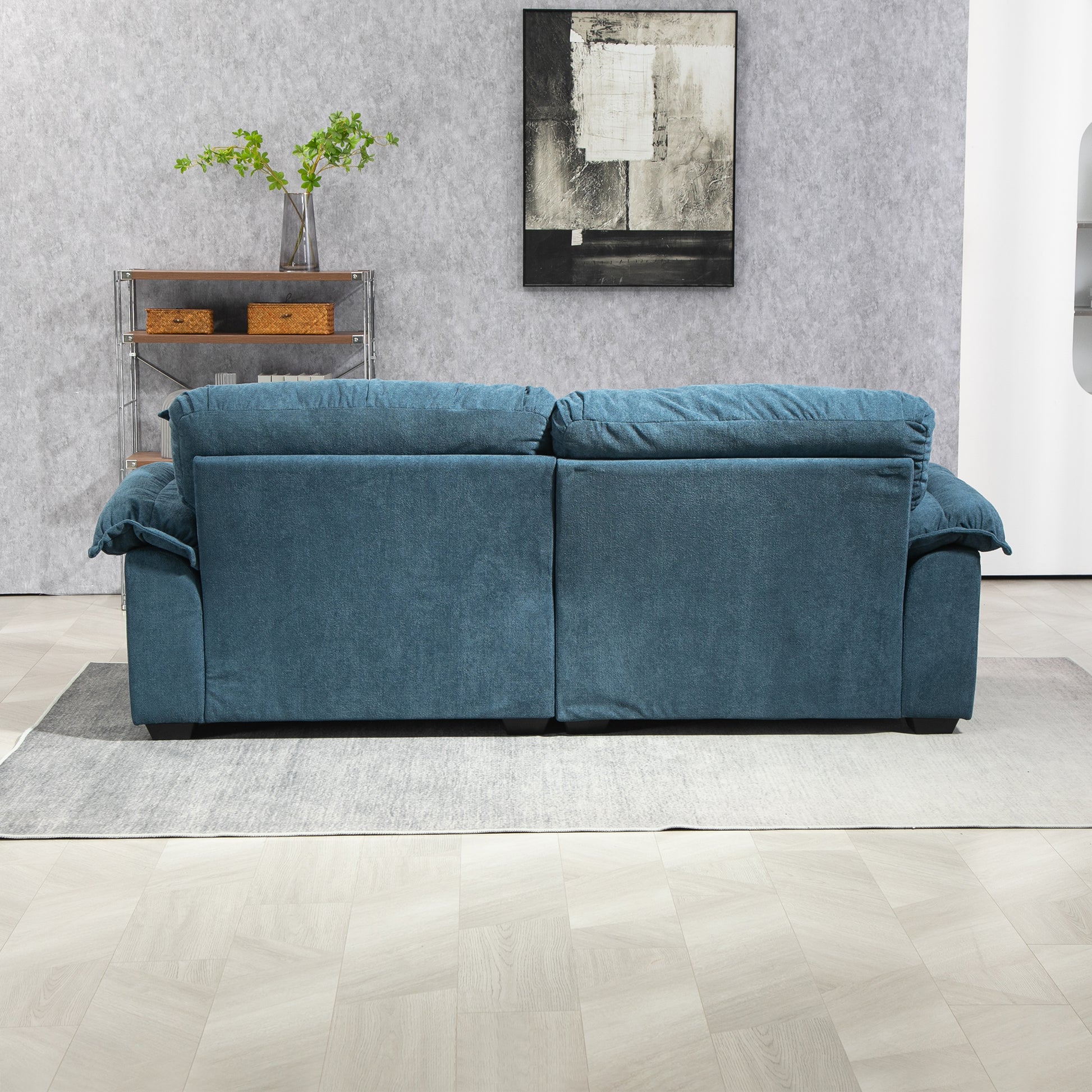 Plush teal sofa with deep cushions and rolled arms perfect for a cozy living room setup