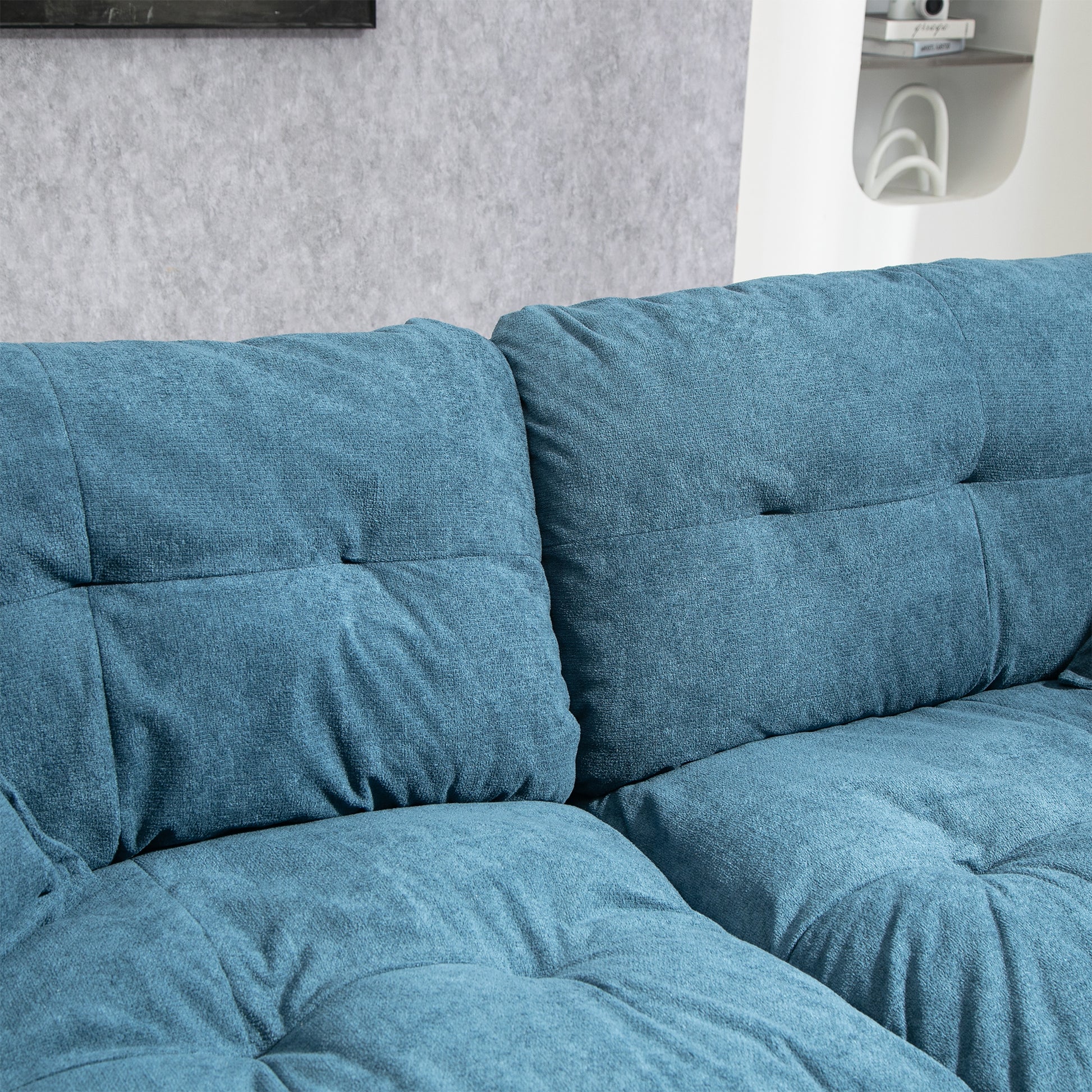 Teal textured fabric sofa cushions with tufted detailing for a modern living room