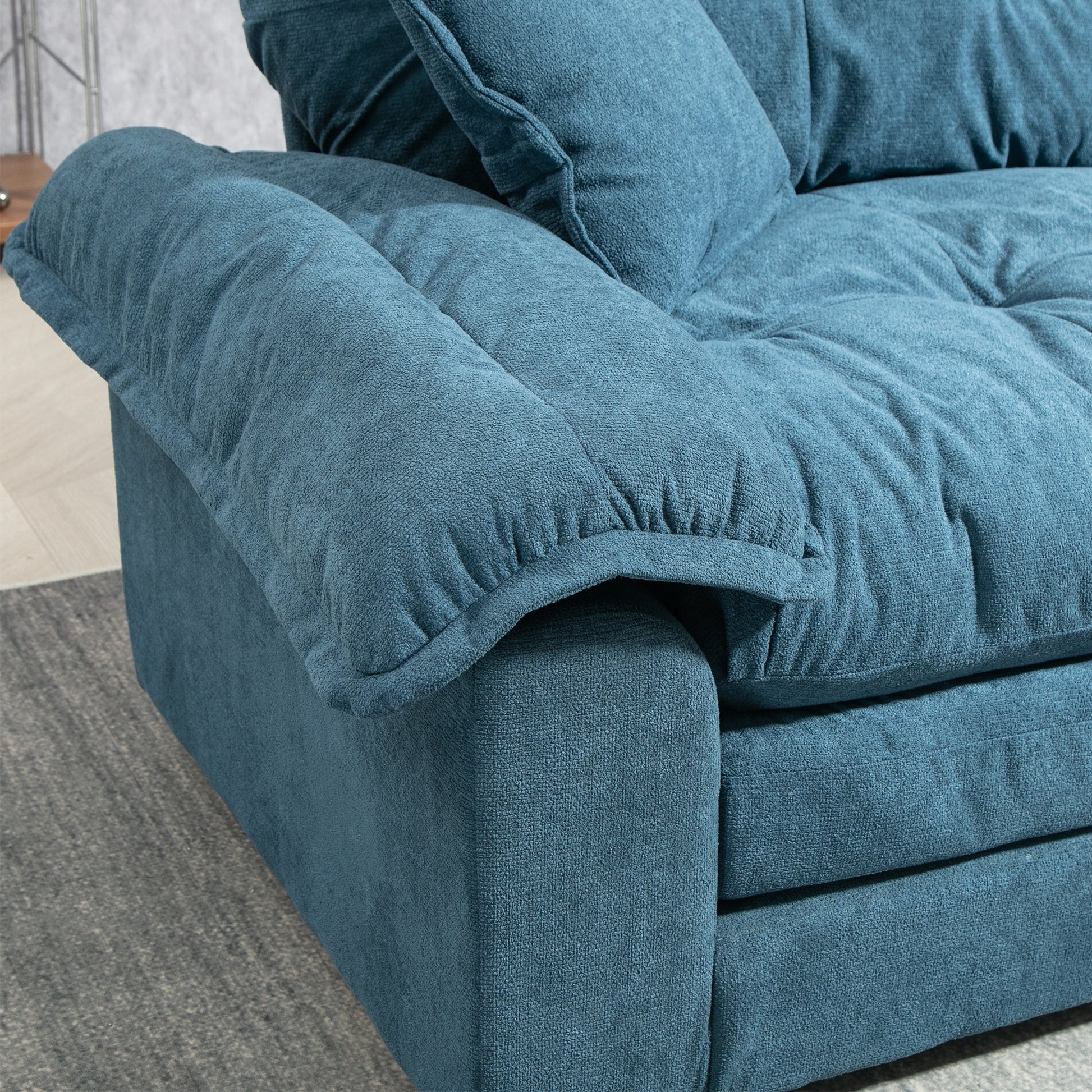 Teal fabric sofa armrest with plush cushioning ideal for living room comfort