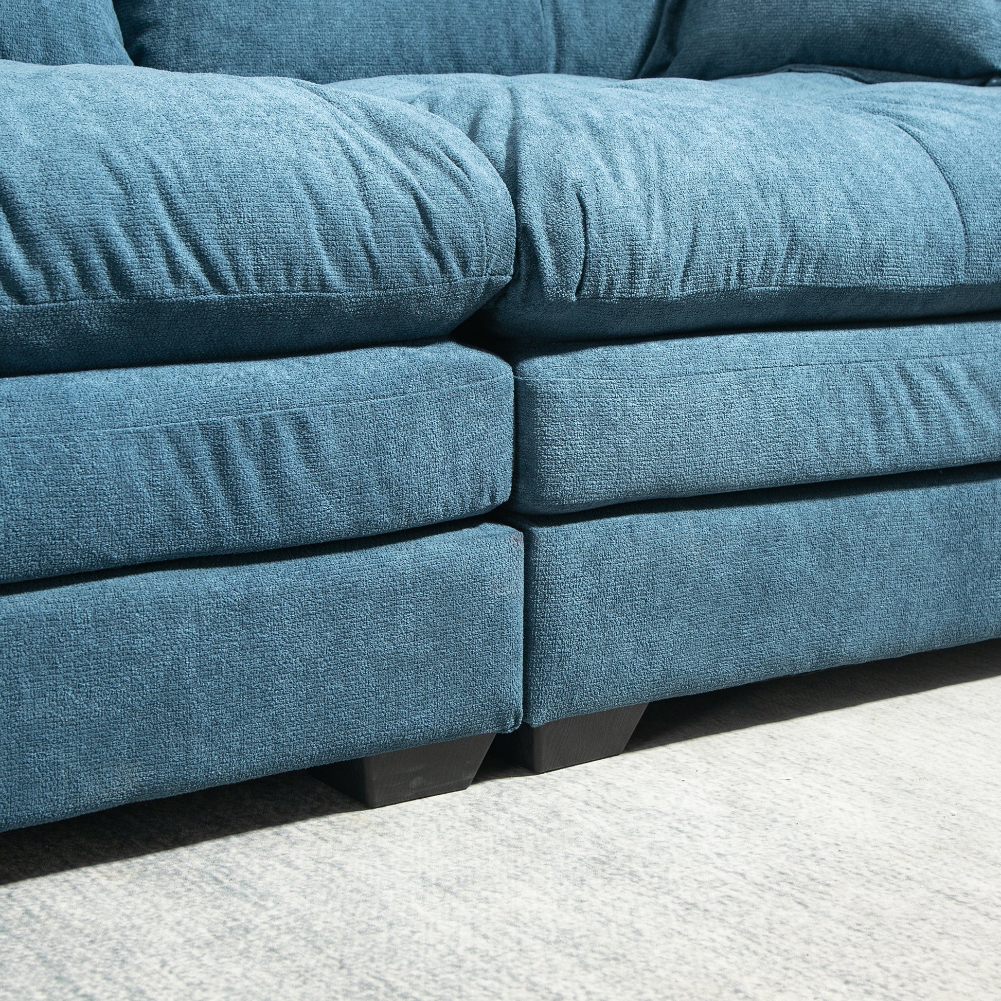 Deep teal textured fabric sofa cushions with plush comfort and sturdy dark block feet