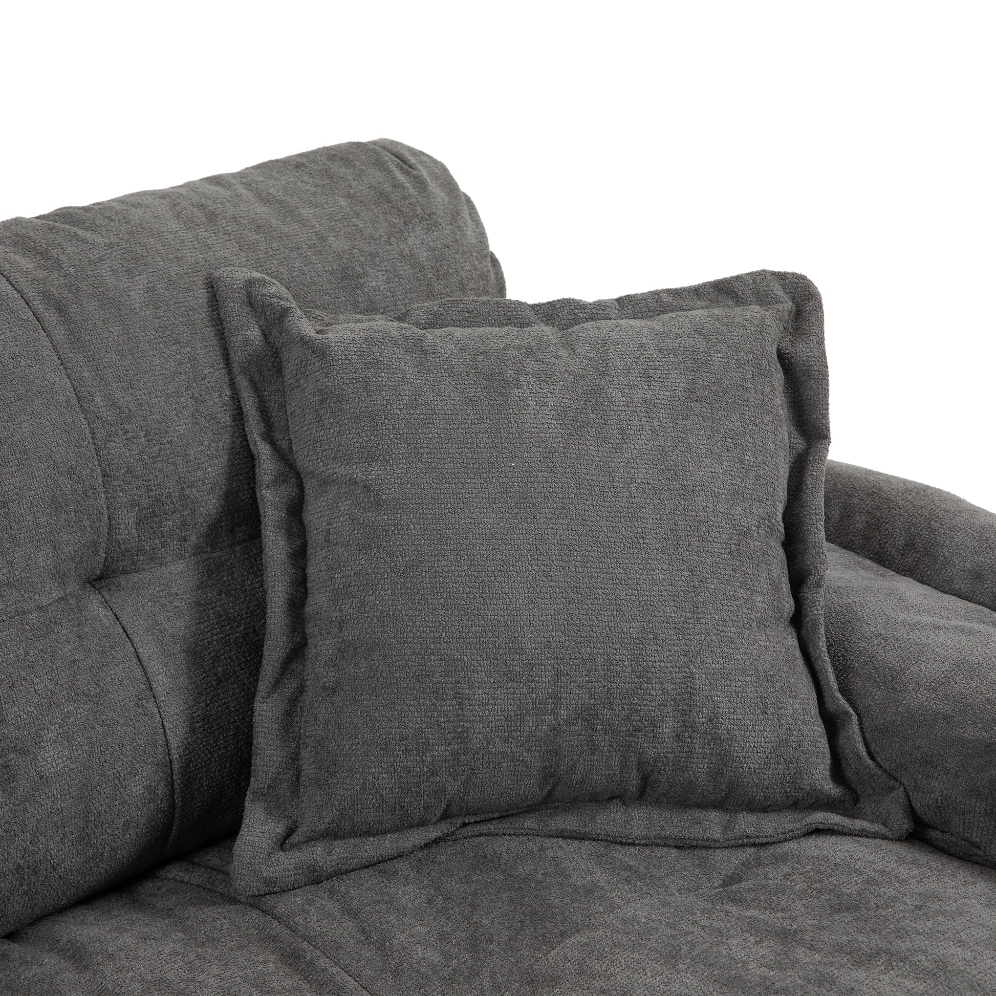 Close up of a charcoal grey textured throw pillow on a matching sofa