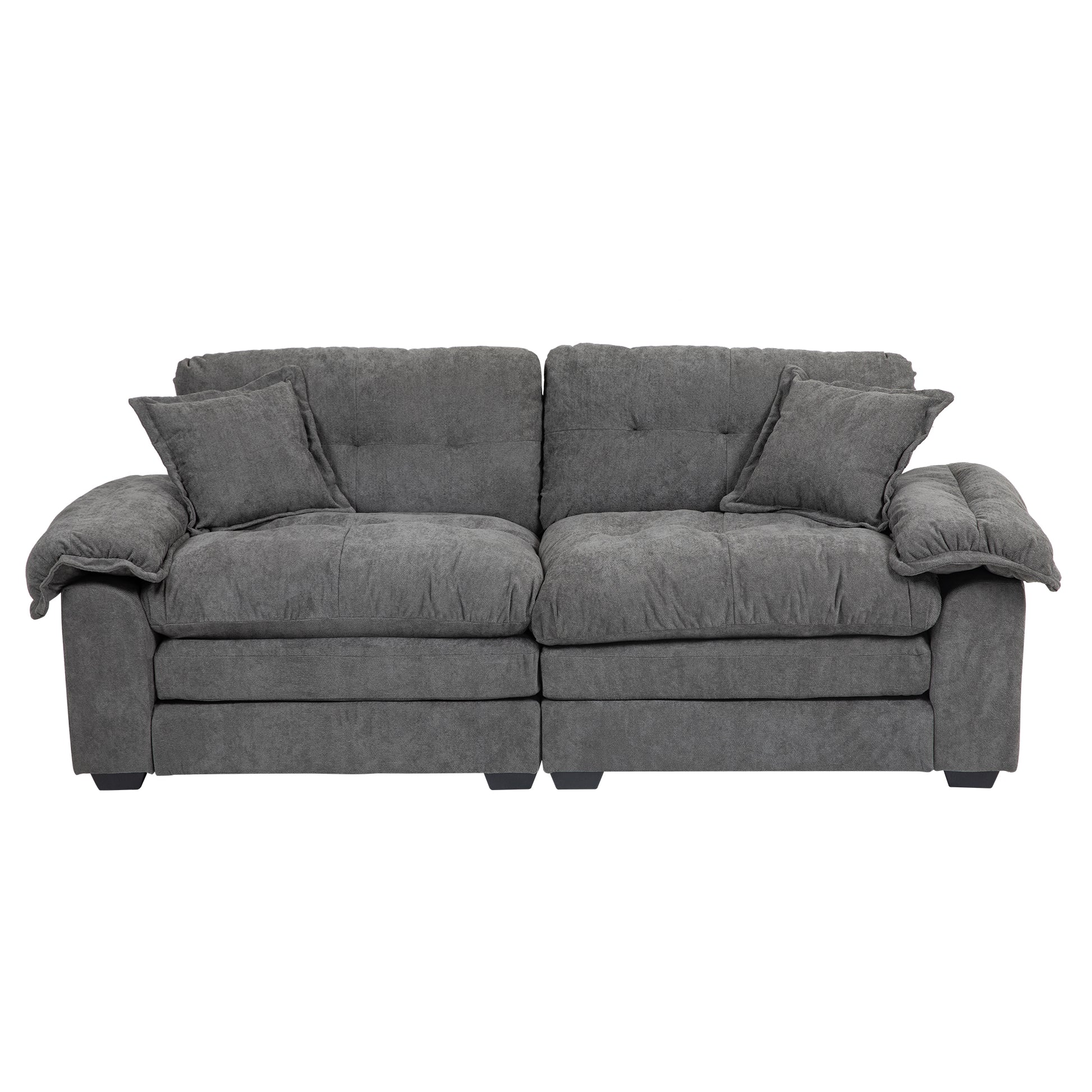 Charcoal grey plush fabric sofa with two accent pillows and tufted back cushions