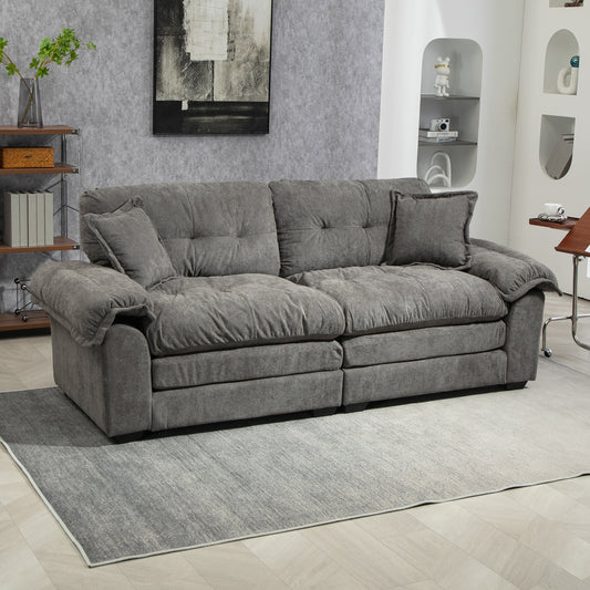 Plush gray fabric sofa with deep tufted cushions and a comfortable modern design
