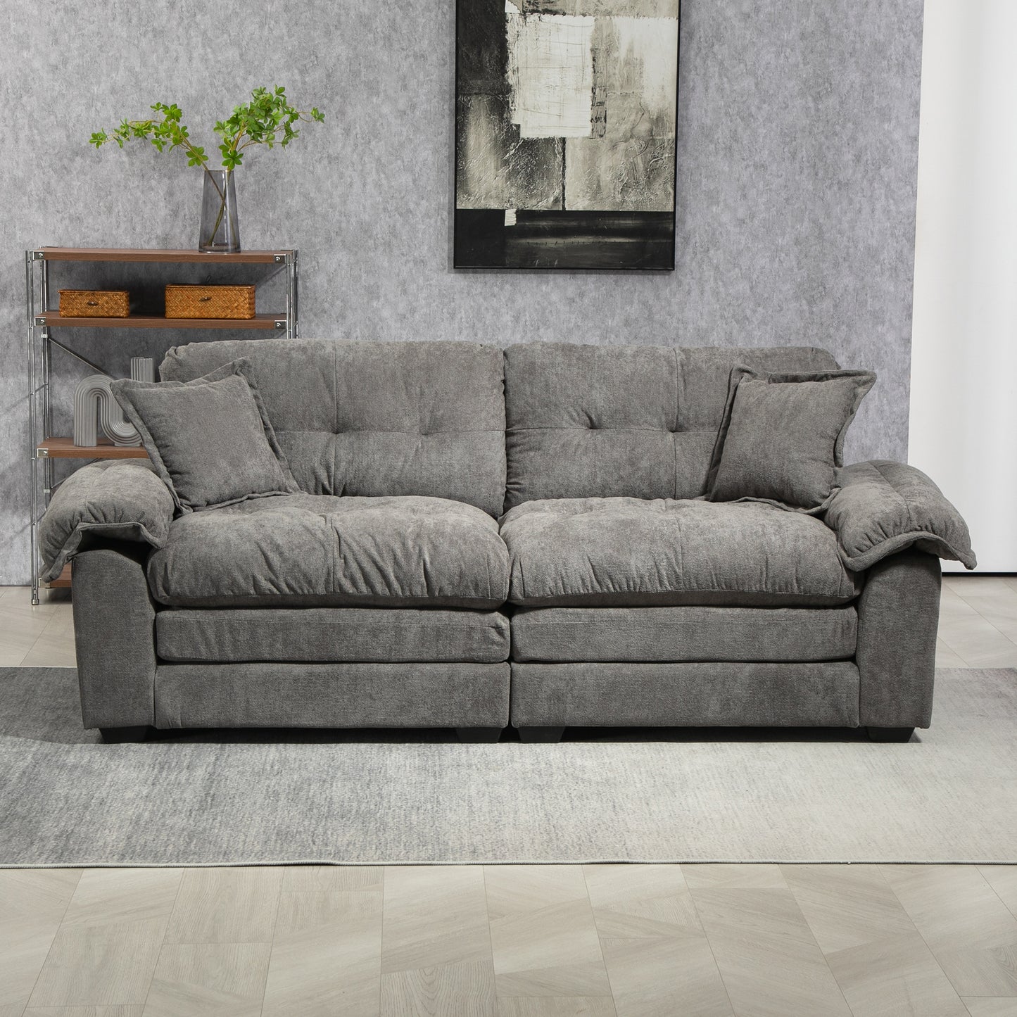 Plush grey fabric sofa with deep seat cushions and decorative tufting perfect for modern living rooms