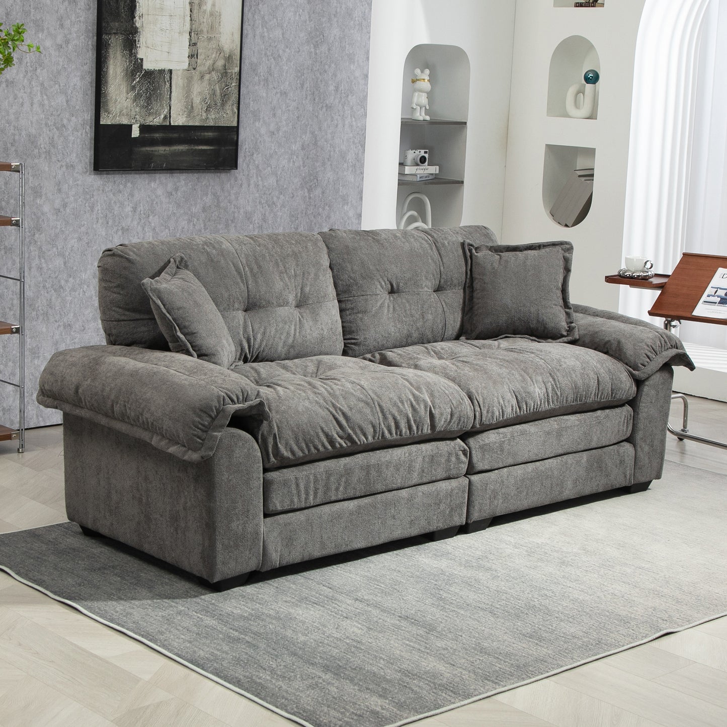 Plush gray fabric sofa with deep tufted cushions and rolled arms perfect for a modern living room