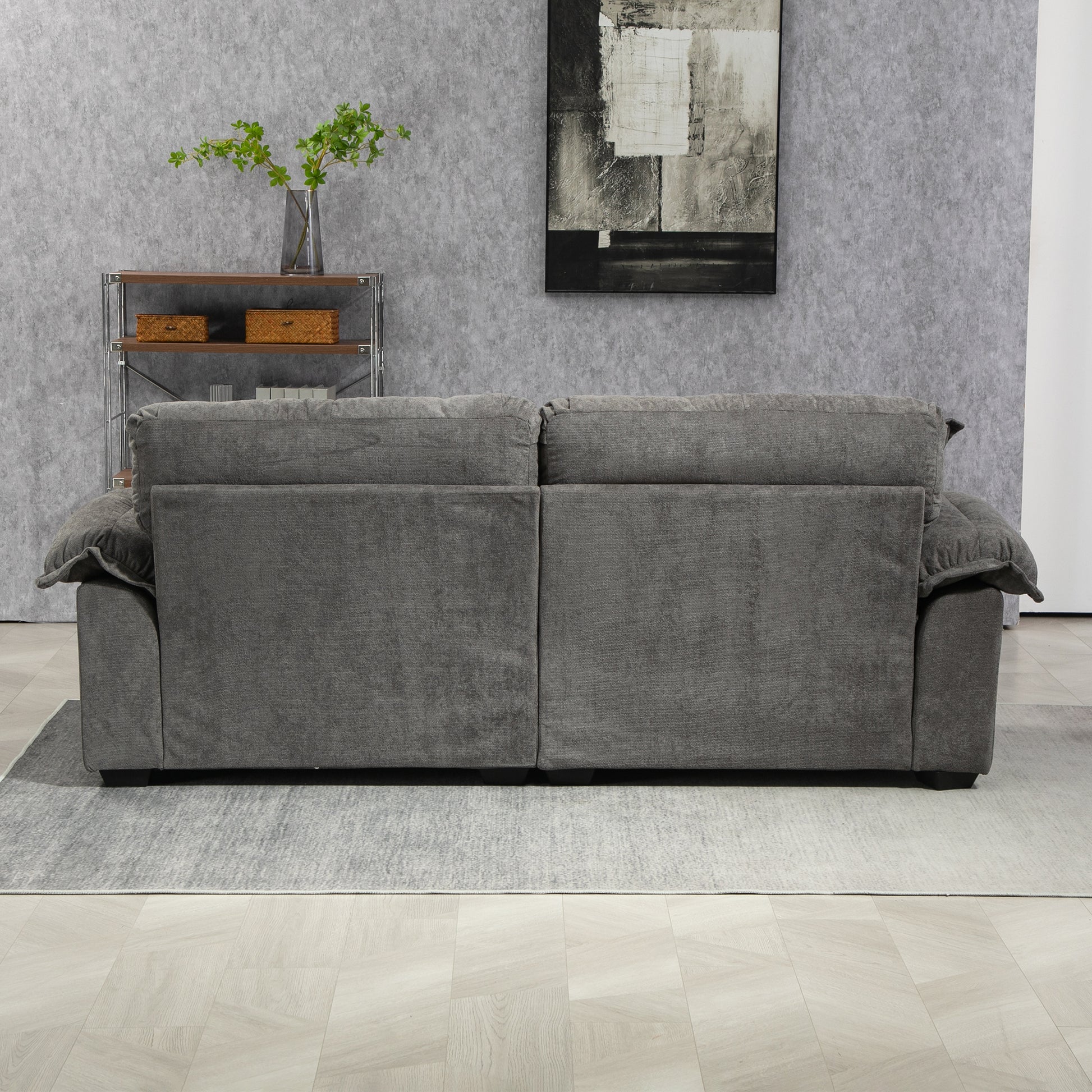 Grey upholstered recliner sofa with plush cushioning and rolled arms  characters