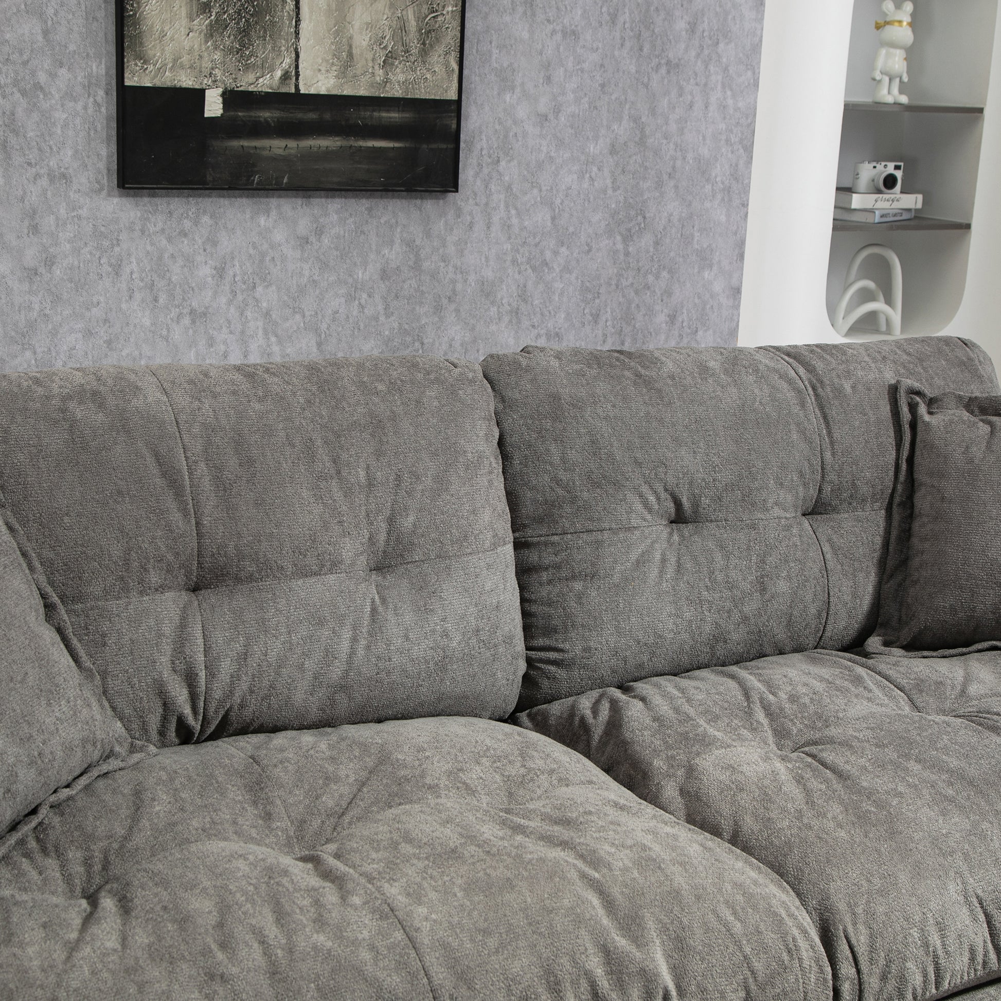 Plush grey fabric sectional sofa with deep tufted cushions for ultimate comfort