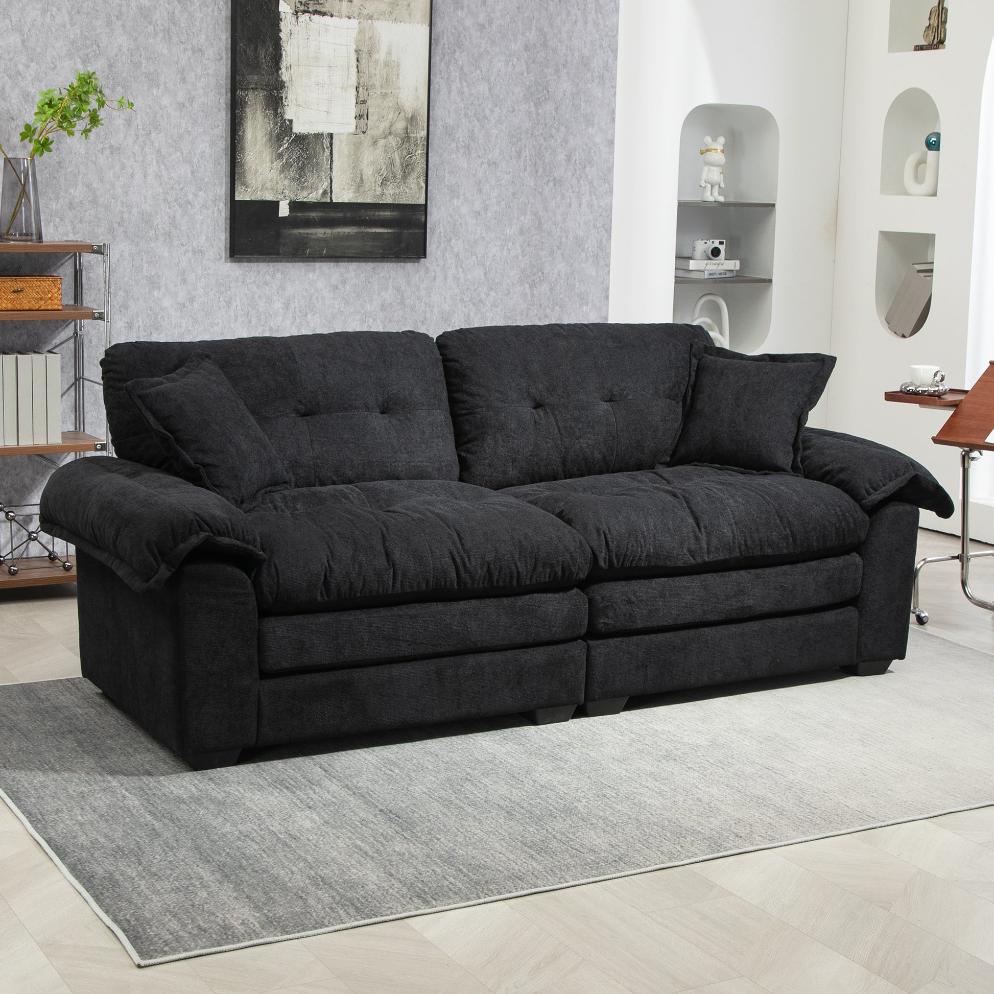 Plush charcoal fabric threeseater sofa with deep seating and tufted cushions for a modern living room
