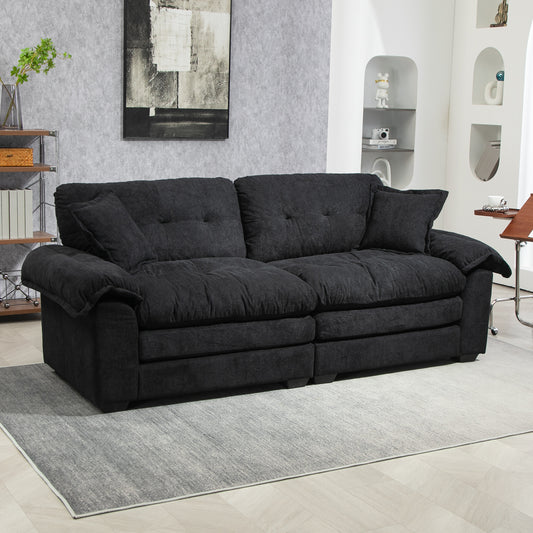 Plush charcoal fabric threeseater sofa with deep seating and tufted cushions for a modern living room