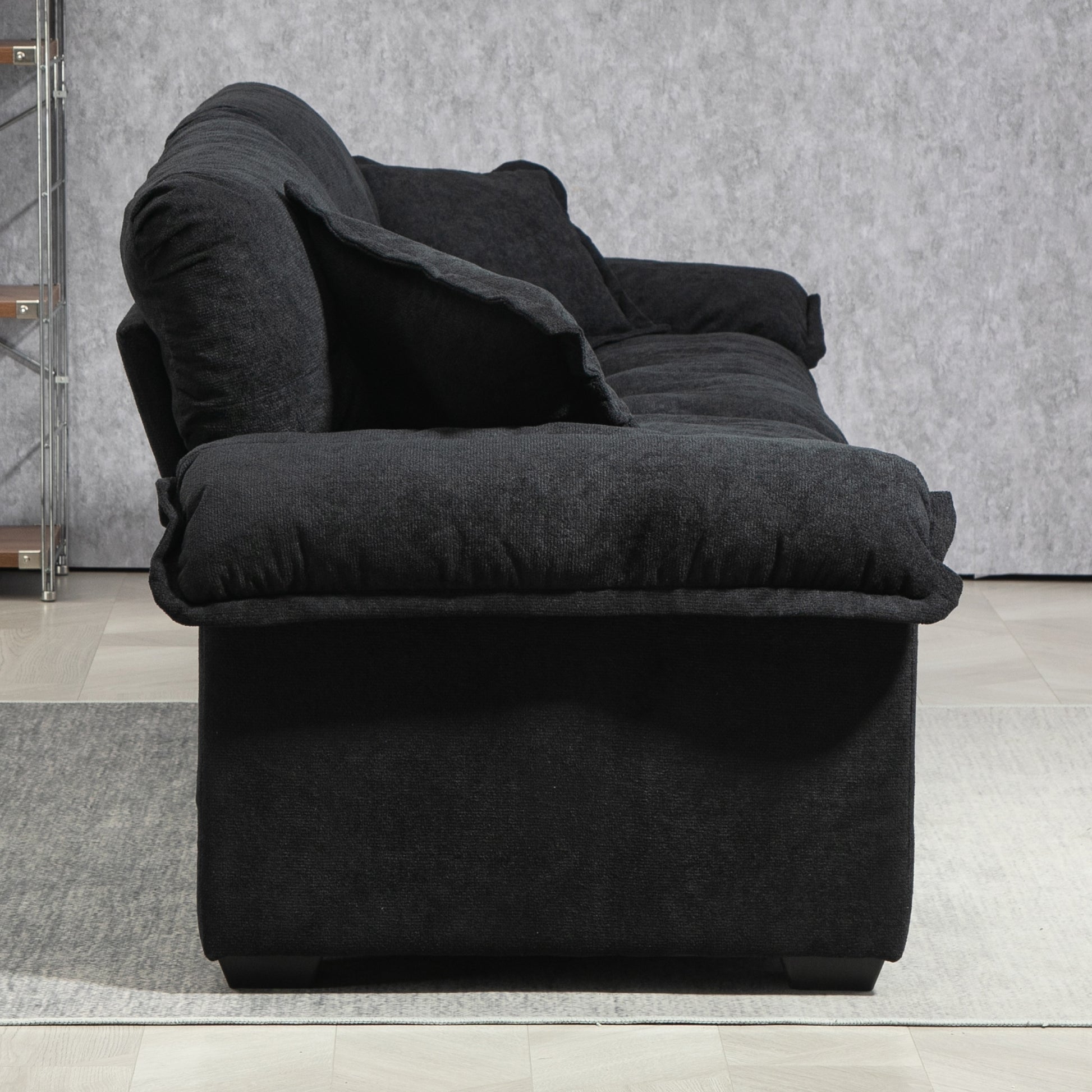 Dark charcoal fabric sofa with plush cushions perfect for modern living rooms