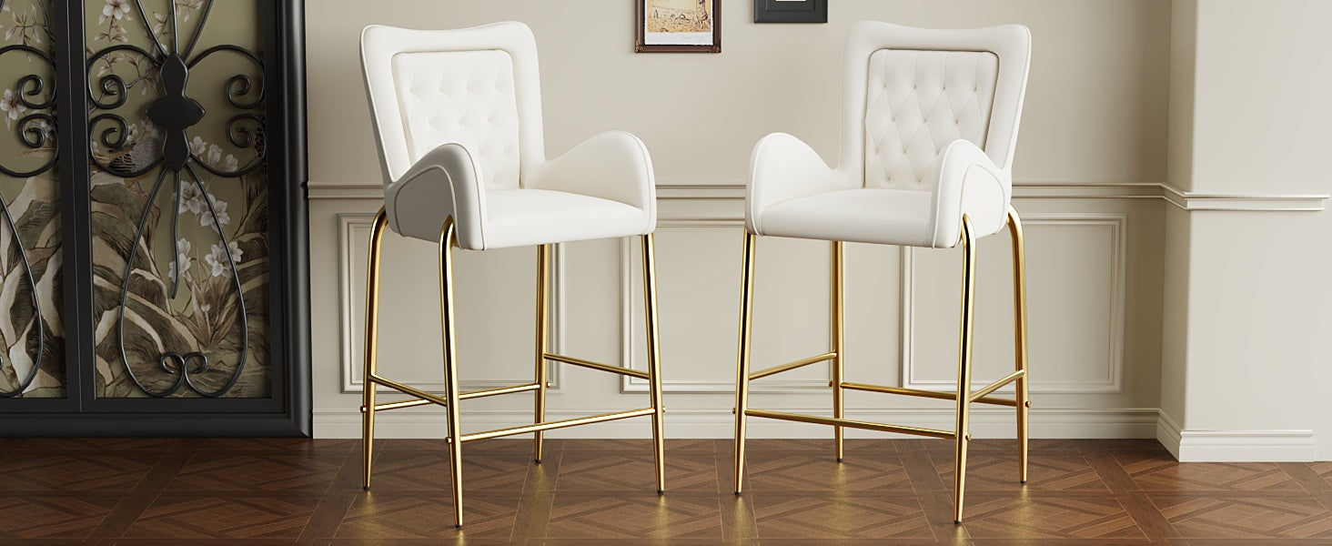 Two white velvet bar stools with diamond tufting and gold legs