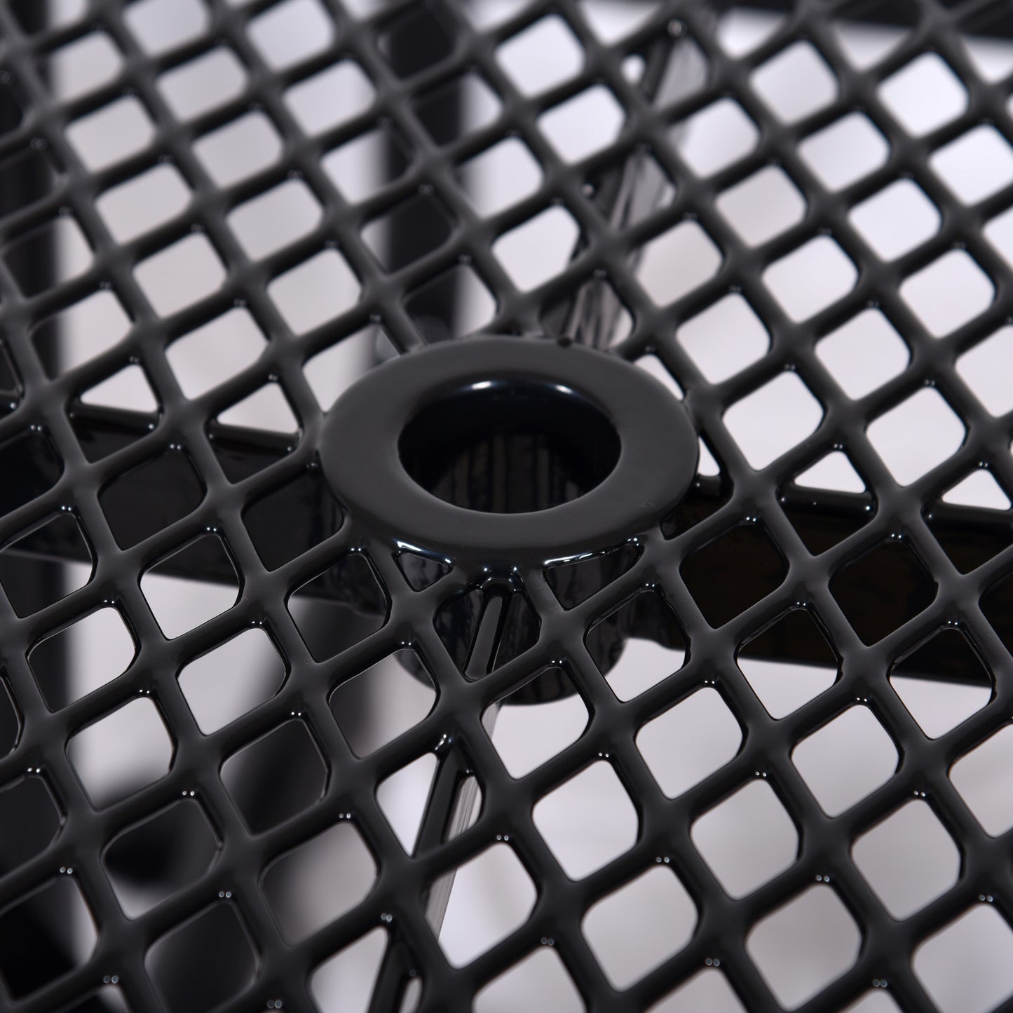 Black metal patio table with diamond pattern mesh surface and umbrella hole
