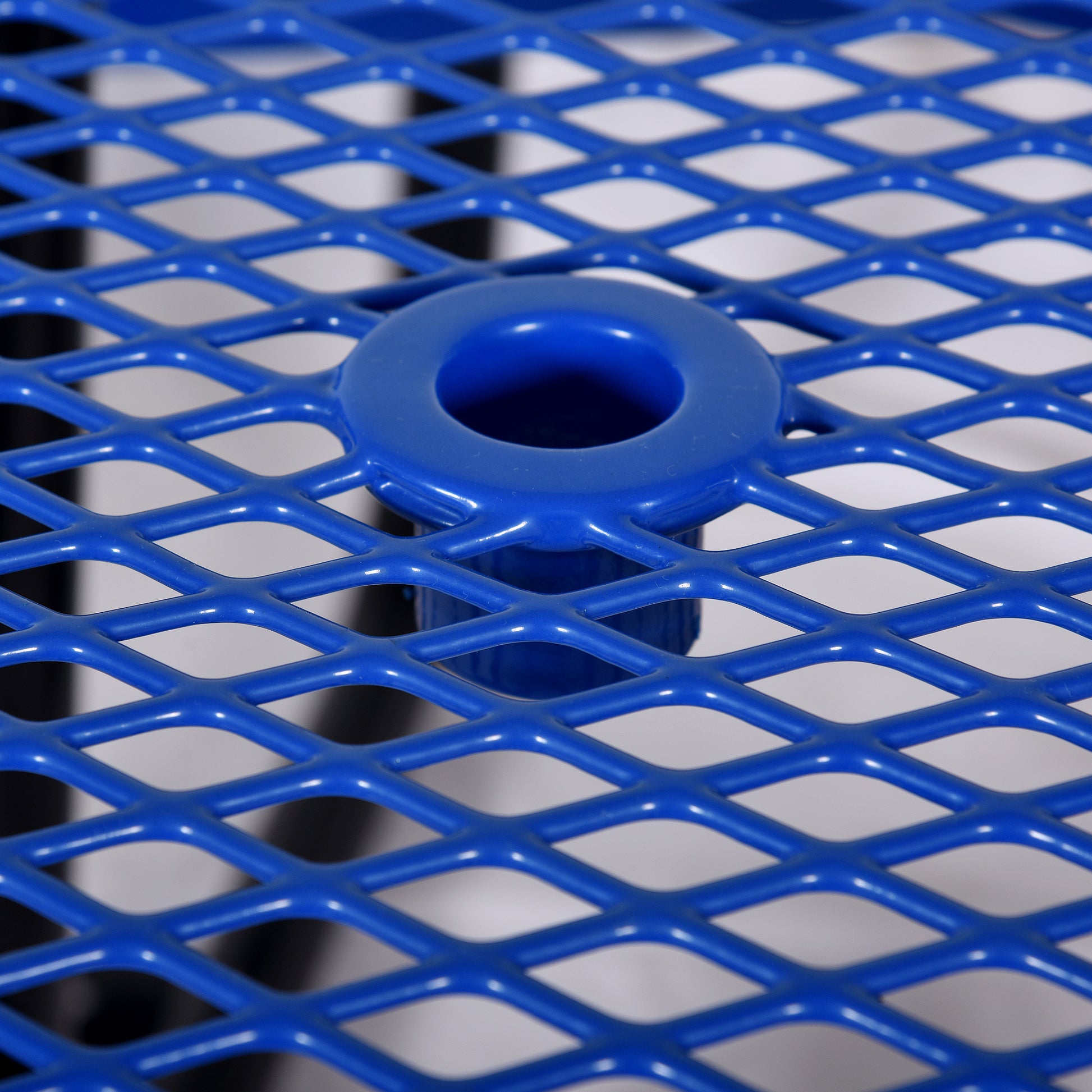 Closeup of a vibrant blue diamond mesh table surface with a central hole ideal for outdoor furniture