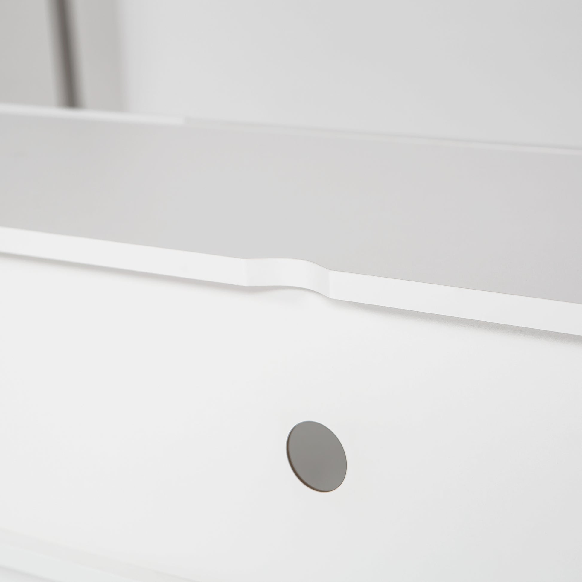 White modern drawer front with silver circular handle cutout