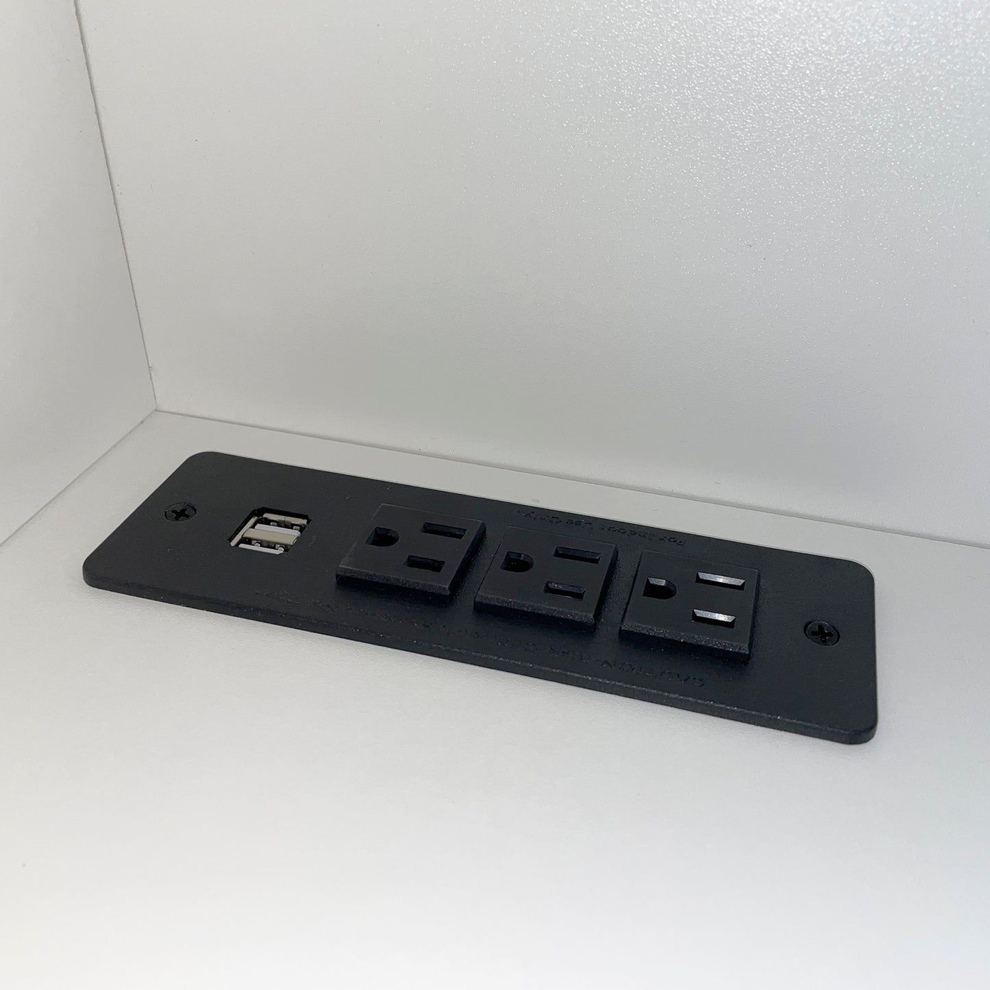 Black power strip with two USB ports and three AC outlets for charging devices