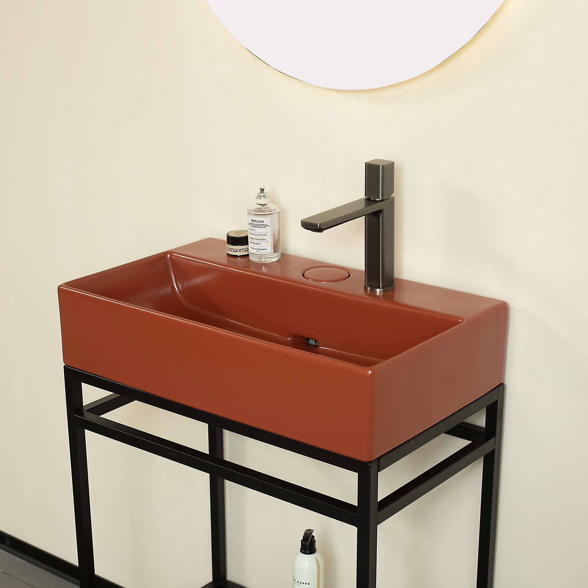 Terracotta rectangular vessel sink with matte black faucet on black metal vanity