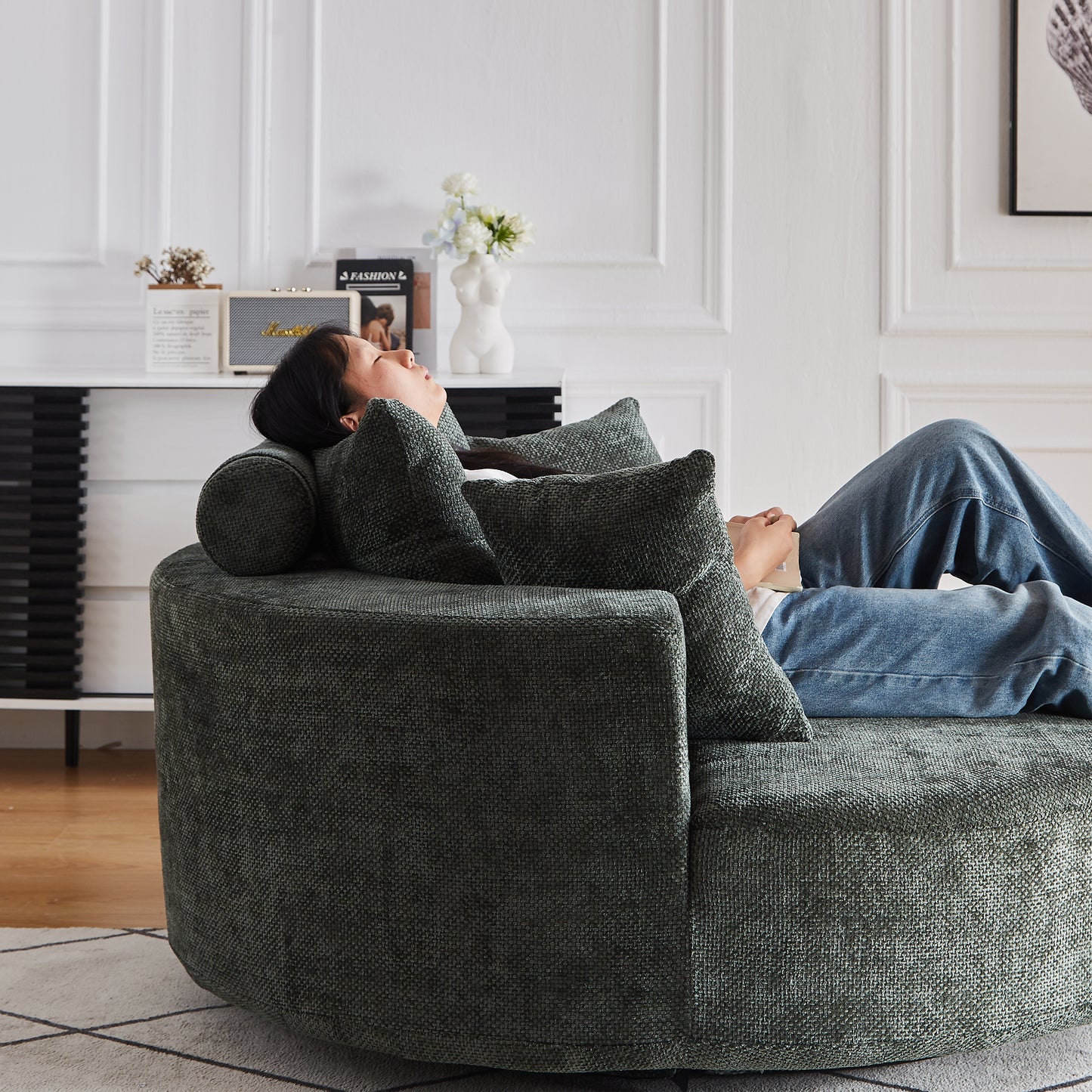 Round charcoal fabric sofa with plush pillows perfect for a cozy living room